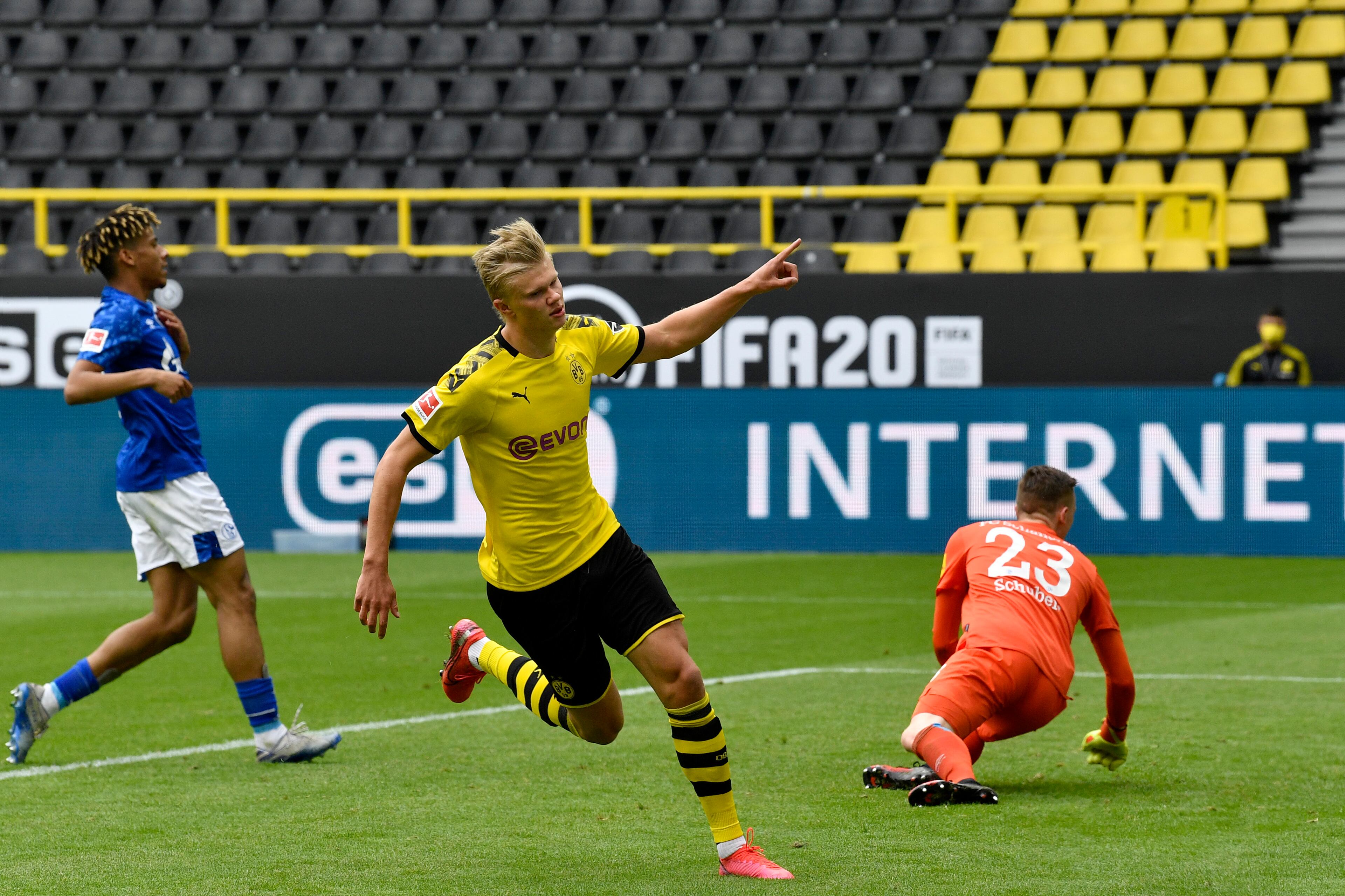 Dortmund's Erling Haaland celebrates after scoring the opening goal during the German Bundesliga soccer match between Borussia Dortmund and Schalke 04 in Dortmund, Germany, Saturday, May 16, 2020. The German Bundesliga becomes the world's first major soccer league to resume after a two-month suspension because of the coronavirus pandemic. (AP Photo/Martin Meissner, Pool)