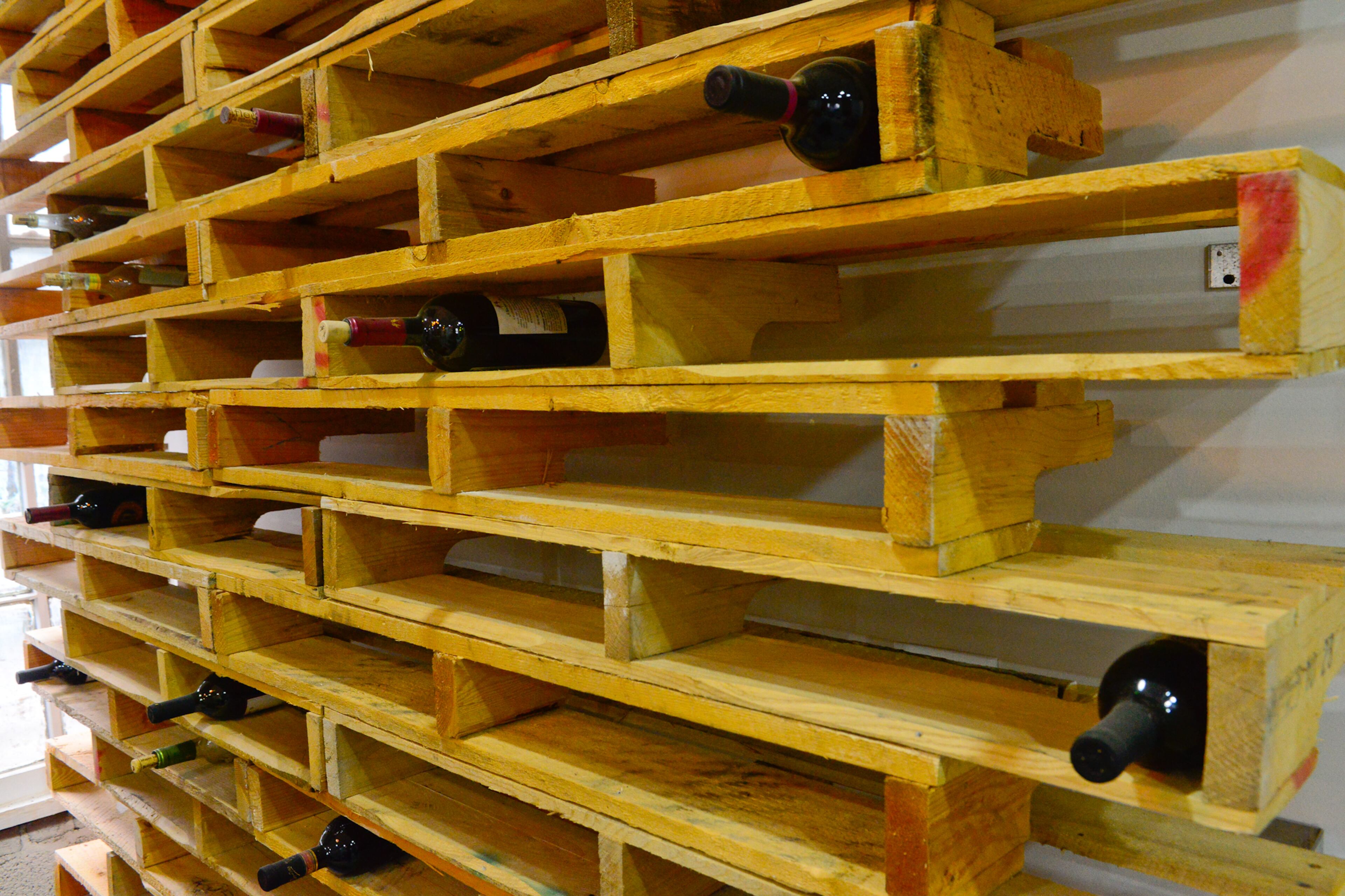 One of the homeowners' favorite pieces of furniture is actually a DIY project. Corey Jones designed and made the wine rack in the basement out of recycled pallets. “It's definitely a piece that people can't get enough of,” Joy Jones says.