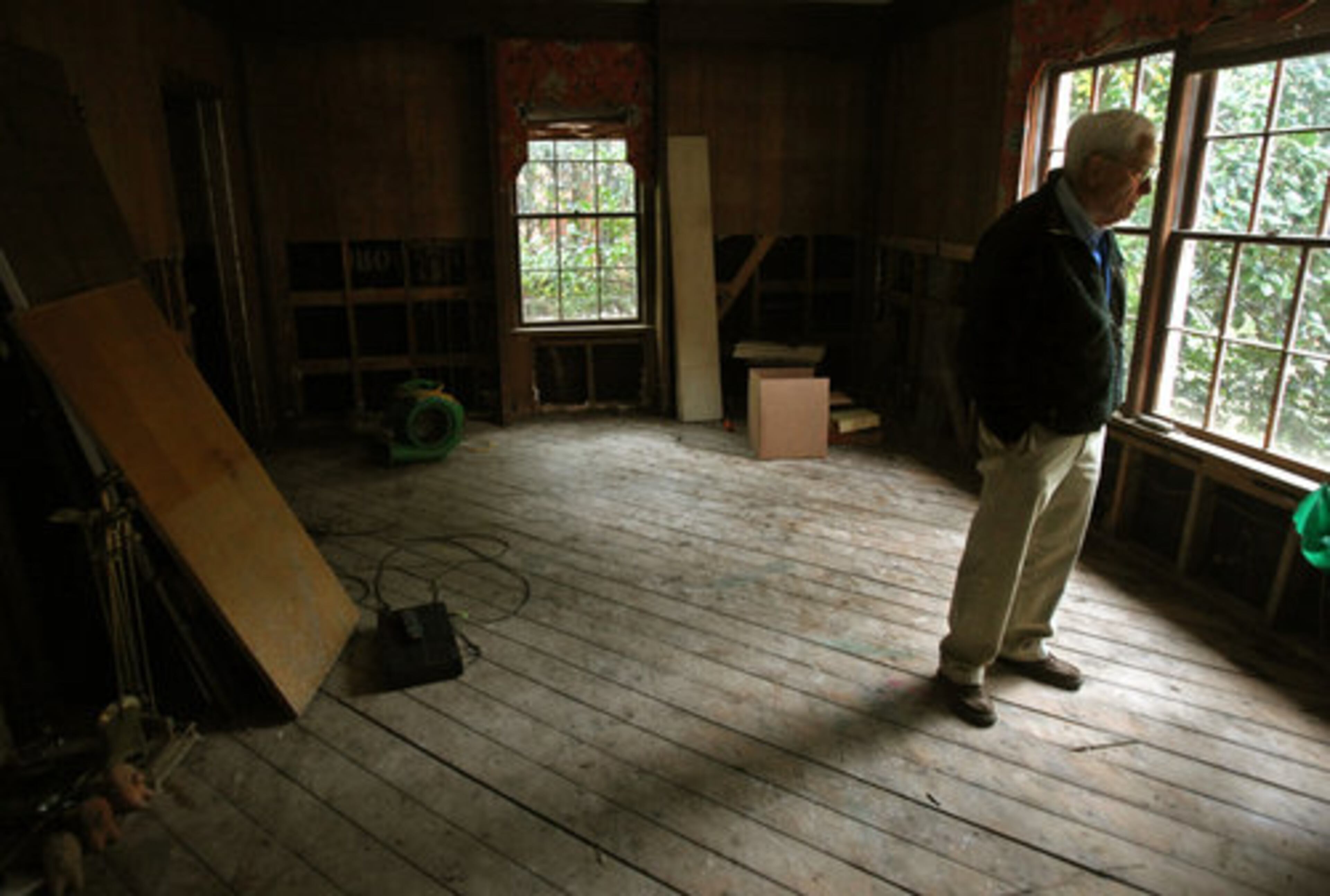 Thorne Winter looks around what is left of his family room after flooding in September damaged his home on Cochise Drive near the Chattahoochee.