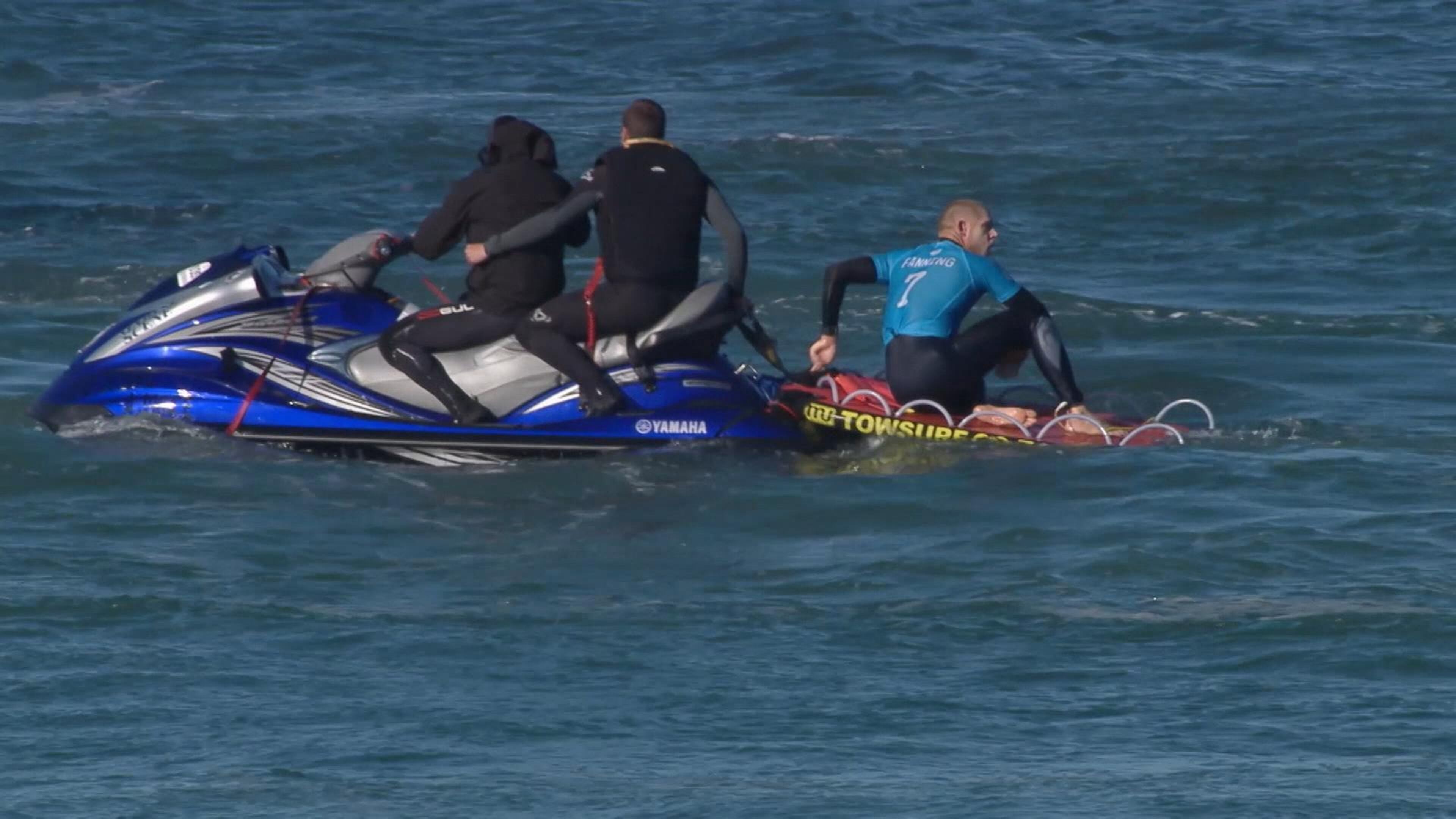 In this screen shot taken from video made available by the World Surf League, Australian surfer Mick Fanning sits on board a rescue boat after being pursued by a shark, in Jeffrey's Bay, South Africa, Sunday, July 19, 2015. Knocked off his board by an attacking shark, a surfer punched the creature during the televised finals of a world surfing competition in South Africa before escaping. Fanning was attacked by a shark on Sunday during the JBay Open but escaped without injuries. (World Surf League via AP)