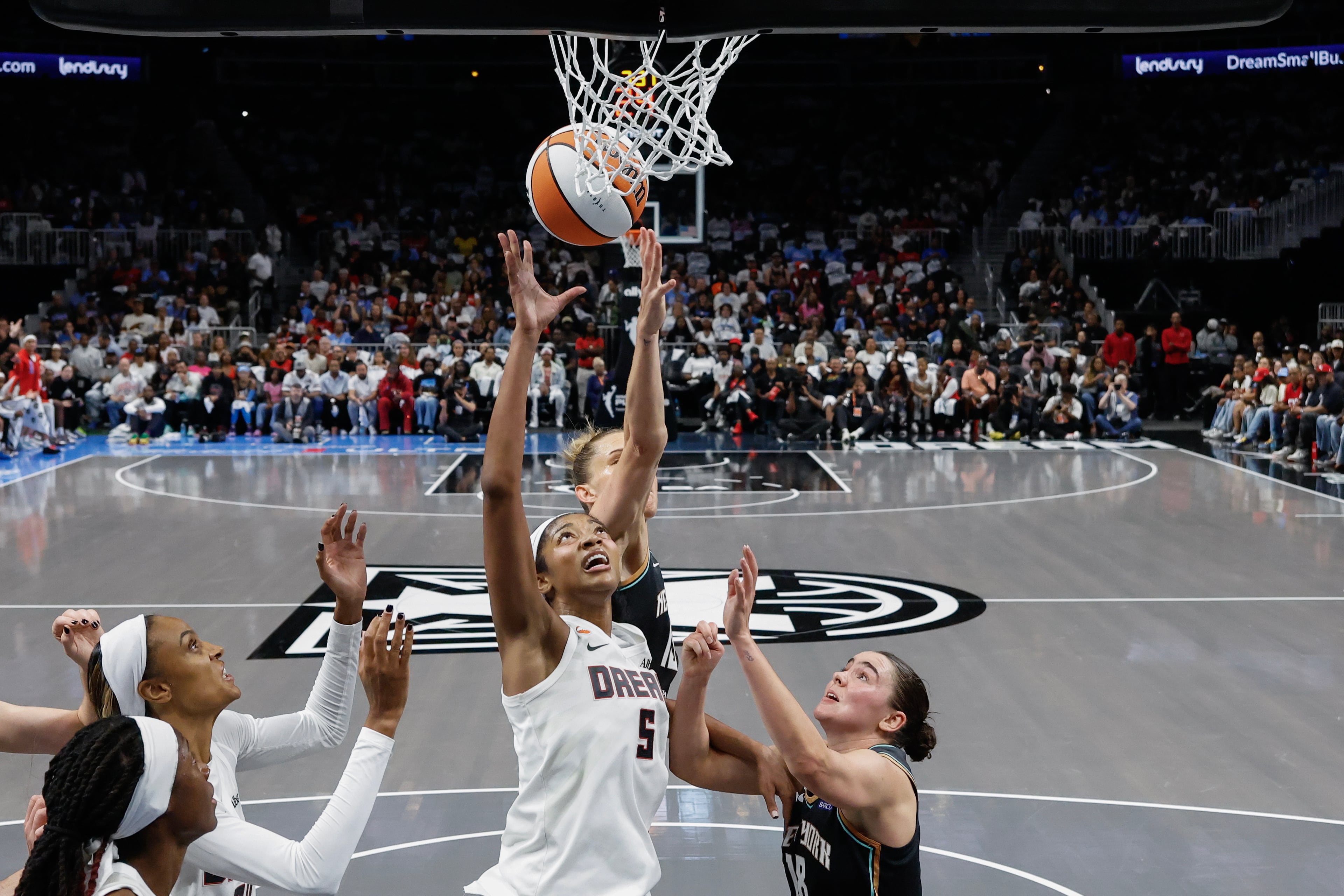Atlanta Dream forward Angel Reese (5) drives to the basket against the New York Liberty during the first half of a WNBA semifinal playoff game 1 between the Atlanta Dream and the New York Liberty, Sunday, Oct. 4, 2026, in Atlanta. (Erik S. Lesser for the AJC)