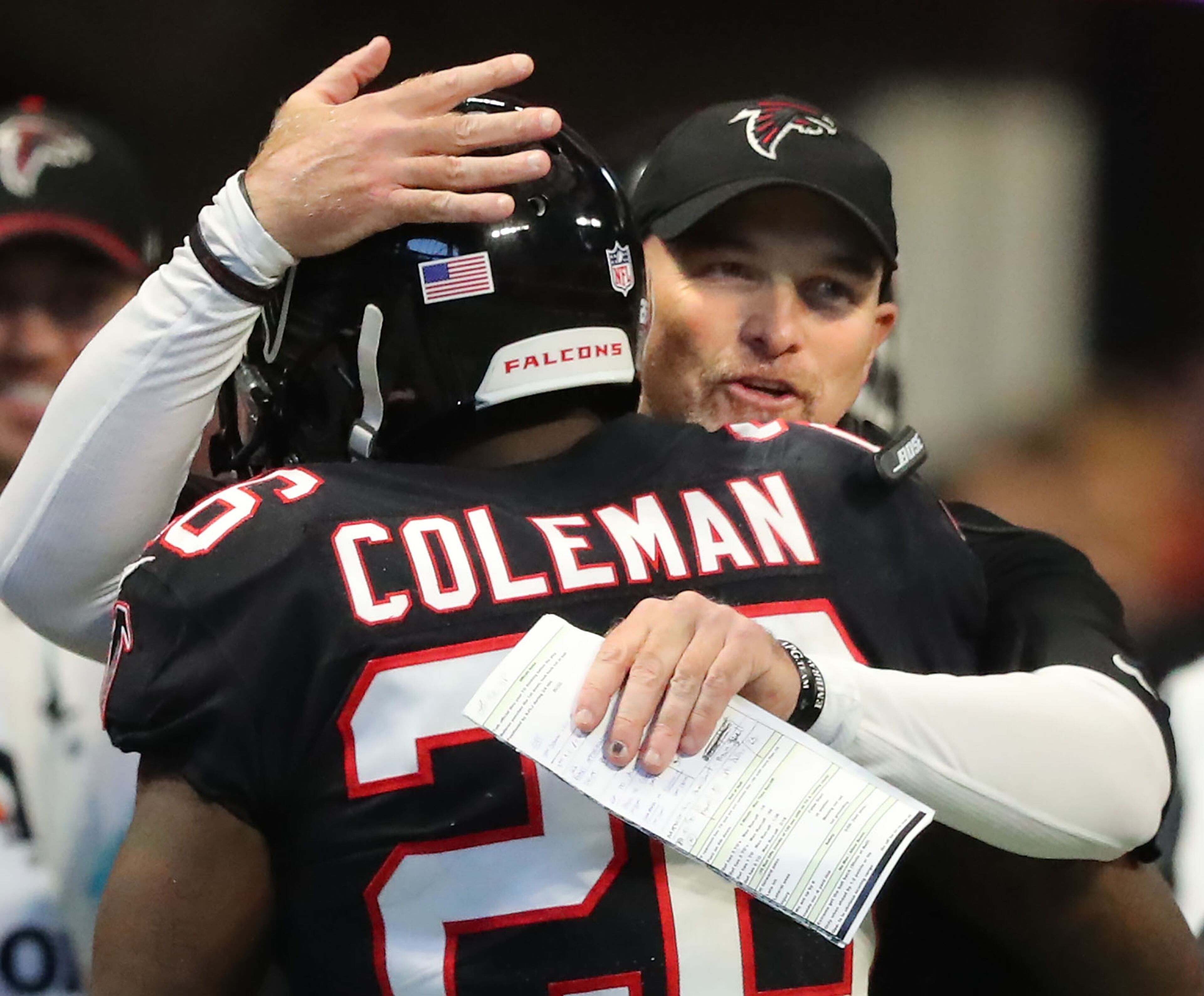 November 26, 2017 Atlanta: Falcons head coach Dan Quinn gives running back Tevin Coleman a hug after his first of two touchdown runs against the Buccaneers during the second half on the way to a 34-20 victory in a NFL football game on Sunday, November 26, 2017, in Atlanta. Curtis Compton/ccompton@ajc.com