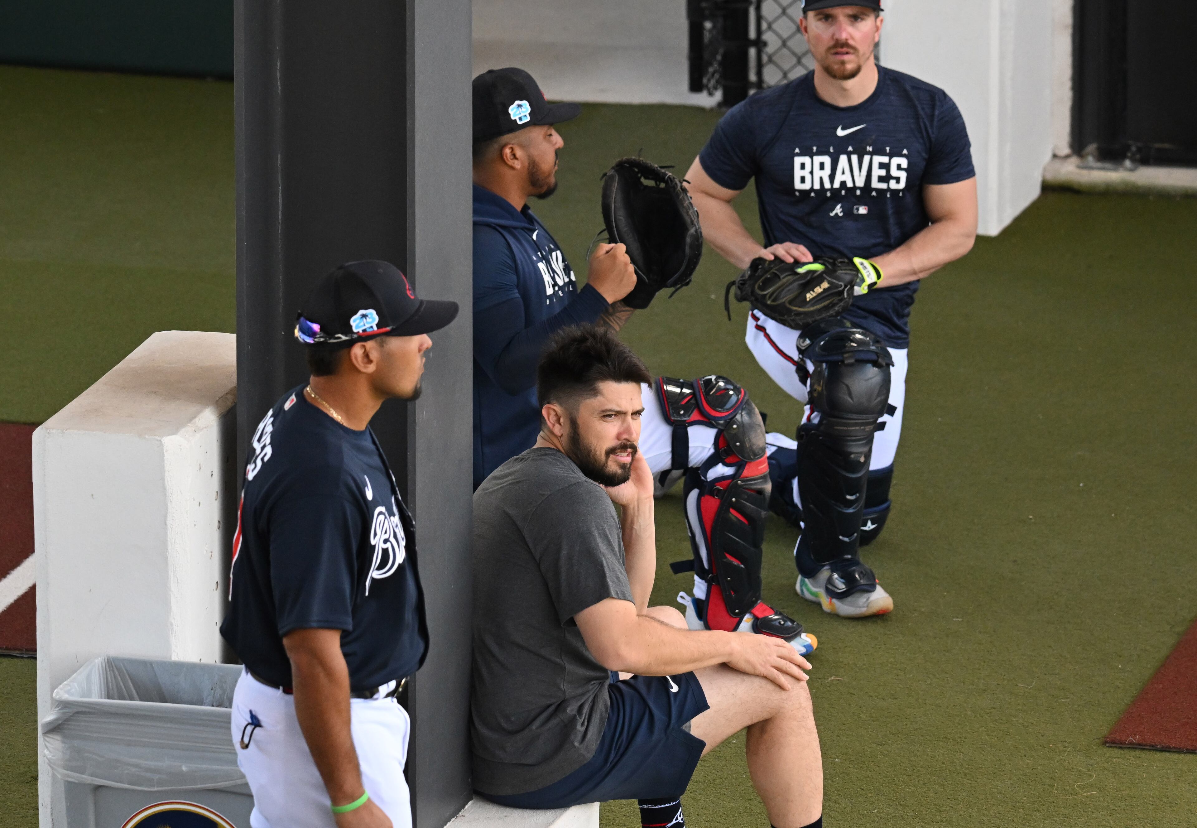 Braves catcher Travis d'Arnaud (foreground) watches catchers' practice Wednesday during spring training at CoolToday Park in North Port, Florida. (Hyosub Shin / Hyosub.Shin@ajc.com)