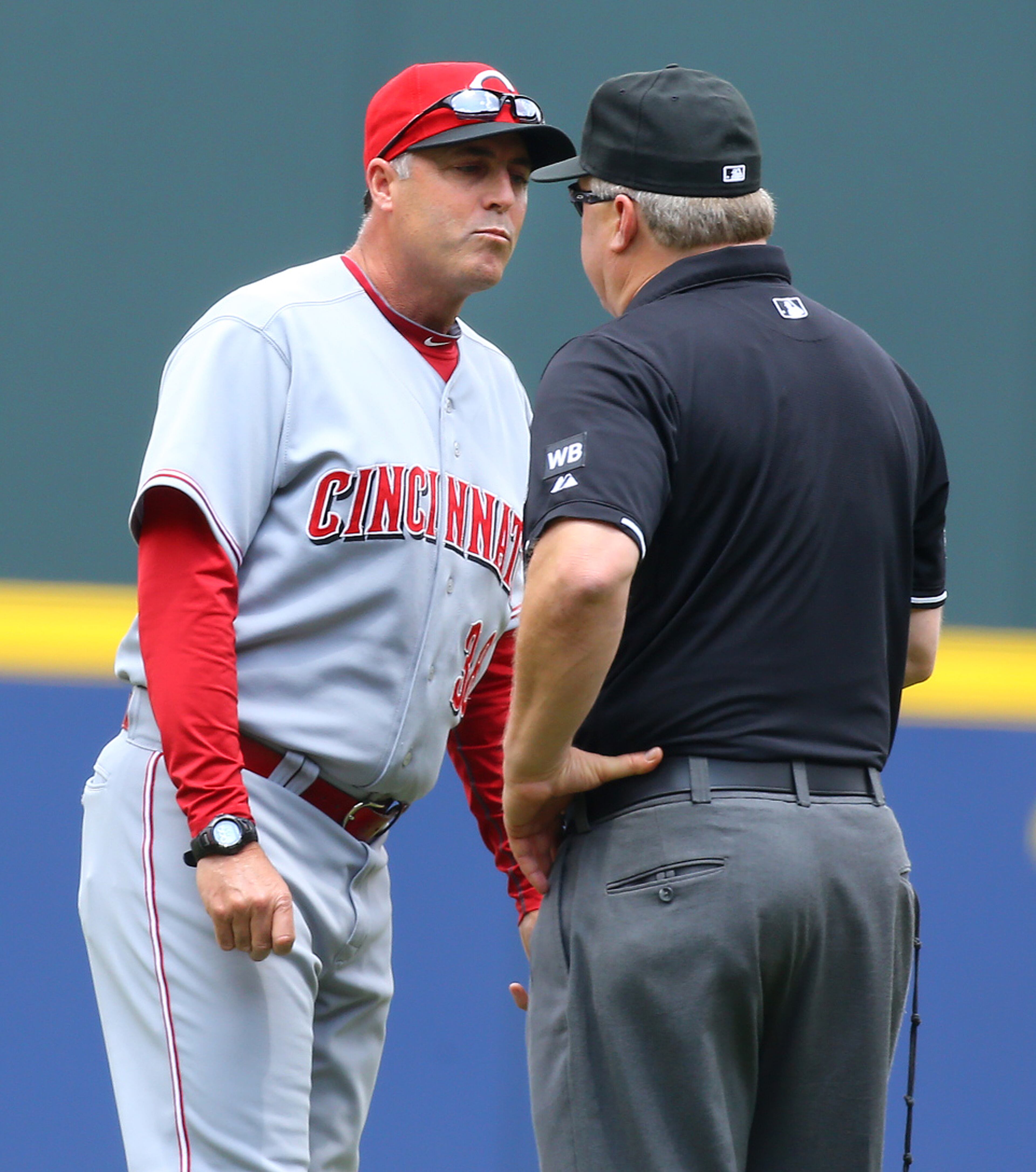 Reds manager Bryan Price is ejected from the game by second base umpire Bill Miller after arguing a first base call following a review during the first inning against the Braves on Sunday, April 27, 2014, in Atlanta. CURTIS COMPTON / CCOMPTON@AJC.COM