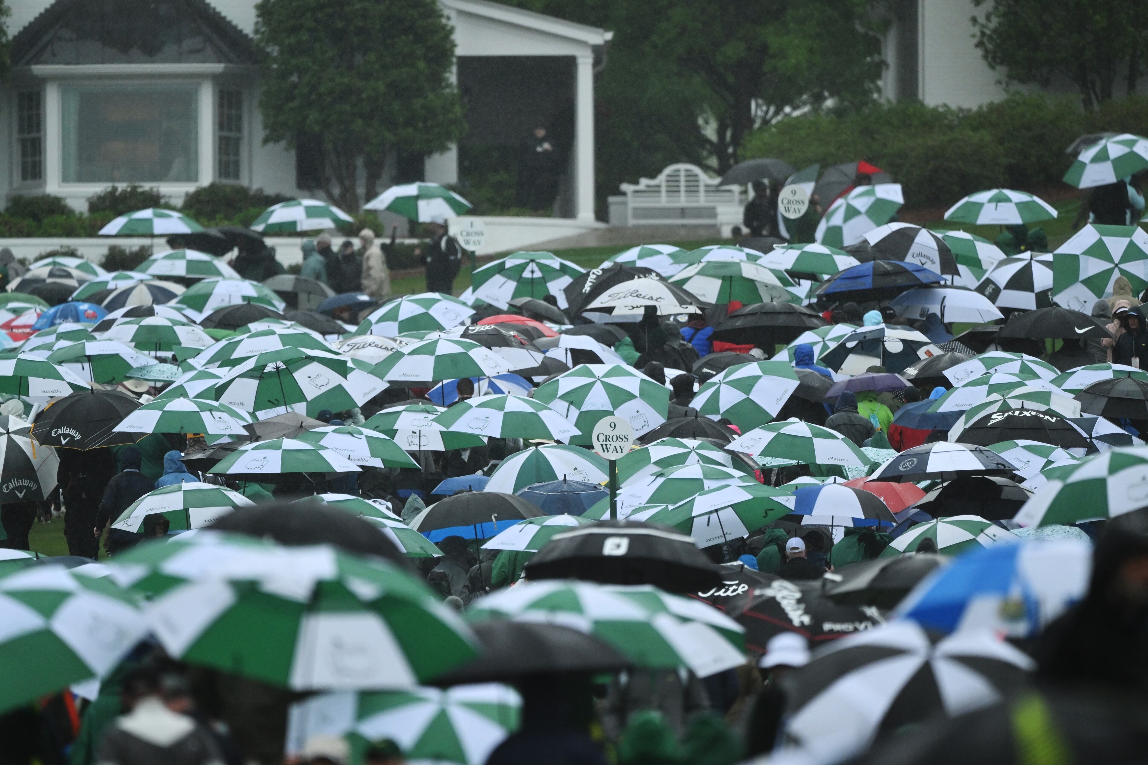 Patrons depart the course as play is suspended during third round of the 2023 Masters Tournament at Augusta National Golf Club, Saturday, April 8, 2023, in Augusta, Ga. (Hyosub Shin / Hyosub.Shin@ajc.com)