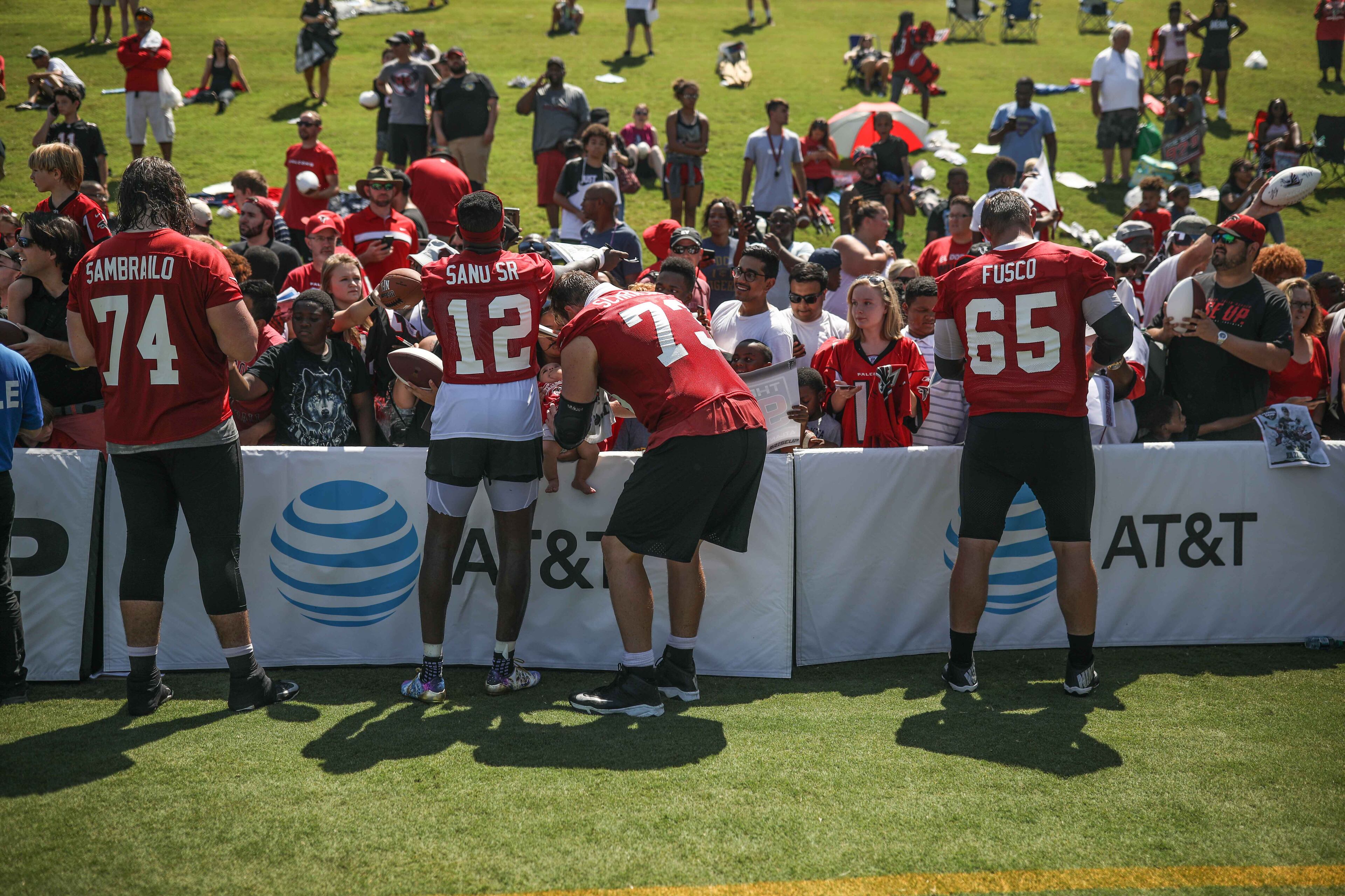 Offensive tackle Ty Sambrailo (74), wide receiver Mohamed Sanu (12), offensive tackle Ryan Schraeder (73) and center Brandon Fusco (65) sign autographs during training camp, Saturday, July 28, 2018, in Flowery Branch, Ga. BRANDEN CAMP/SPECIAL