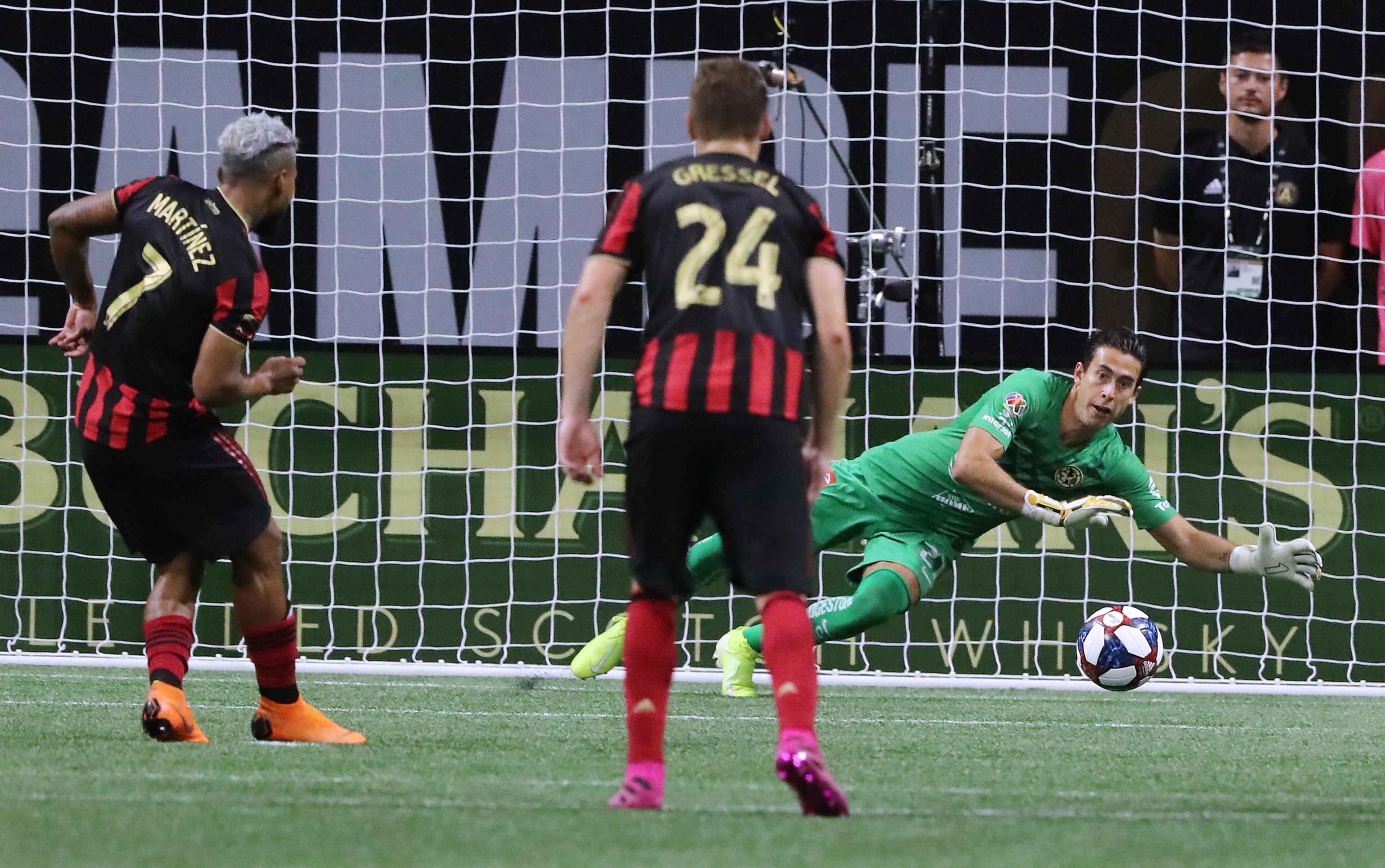 Atlanta United forward Josef Martinez has his penalty kick blocked by Club America goalkeeper Oscar Jimenez as Julian Gressel looks on. Curtis Compton/ccompton@ajc.com