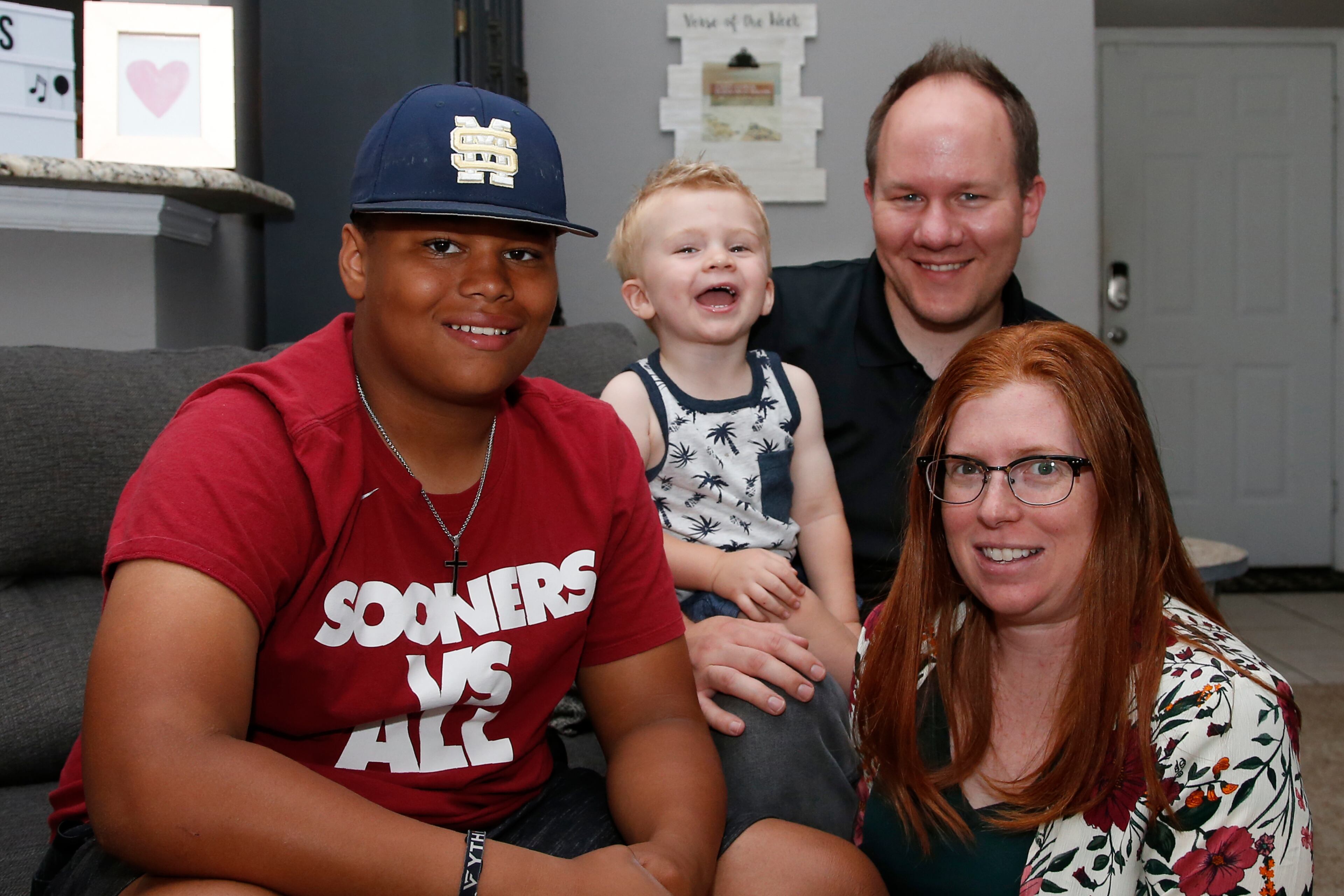 The Dunn family is pictured in their home in Oklahoma City. From left are Izzy Simons, Cooper Dunn, Josh Dunn and Sarah Dunn. Sarah, who grew up in rural Kansas, has learned much about race since she and her husband, Josh, took custody of Izzy six years ago.