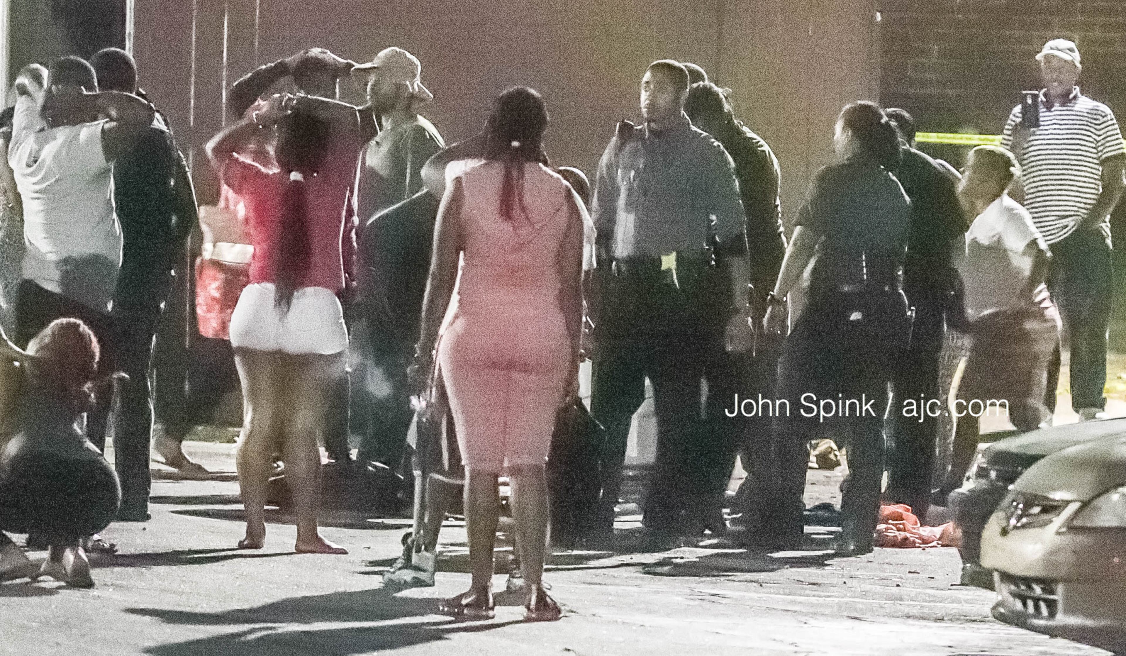South Fulton police officers speak with a crowd gathered in the parking lot of the Hickory Park apartment complex on Delano Road on Wednesday morning.