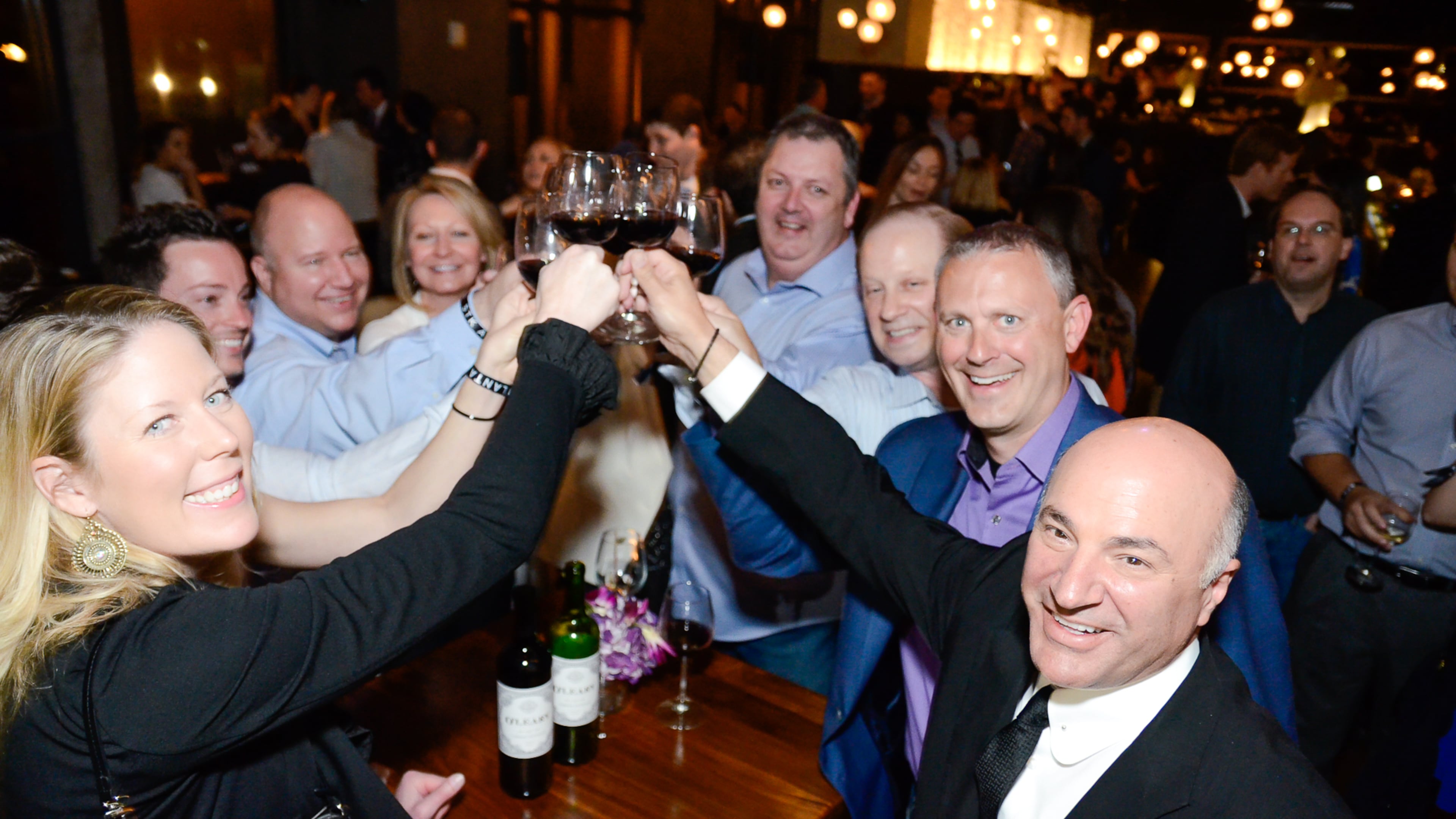 Kevin O'Leary toasts with staff of a company he partially owns called IOU Central, which lends money to small businesses. CREDIT: Tomas Espinoza