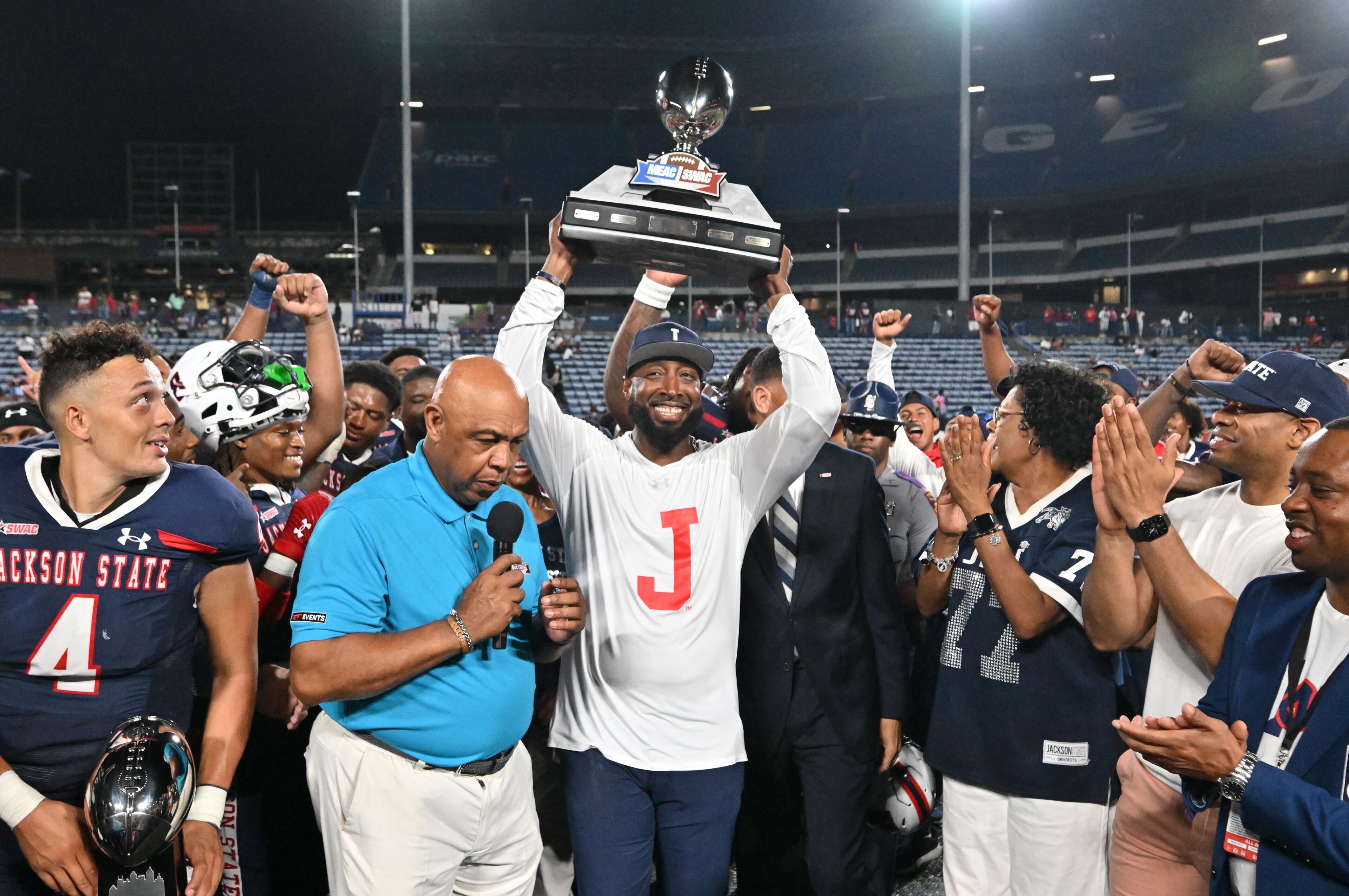 Jackson State's head coach T.C. Taylor holds up the trophy to celebrate the victory during the 2023 MEAC/SWAC Challenge at Center Parc Stadium, Saturday, August 26, 2023, in Atlanta. Jackson State won 37-7 over South Carolina State. (Hyosub Shin / Hyosub.Shin@ajc.com)