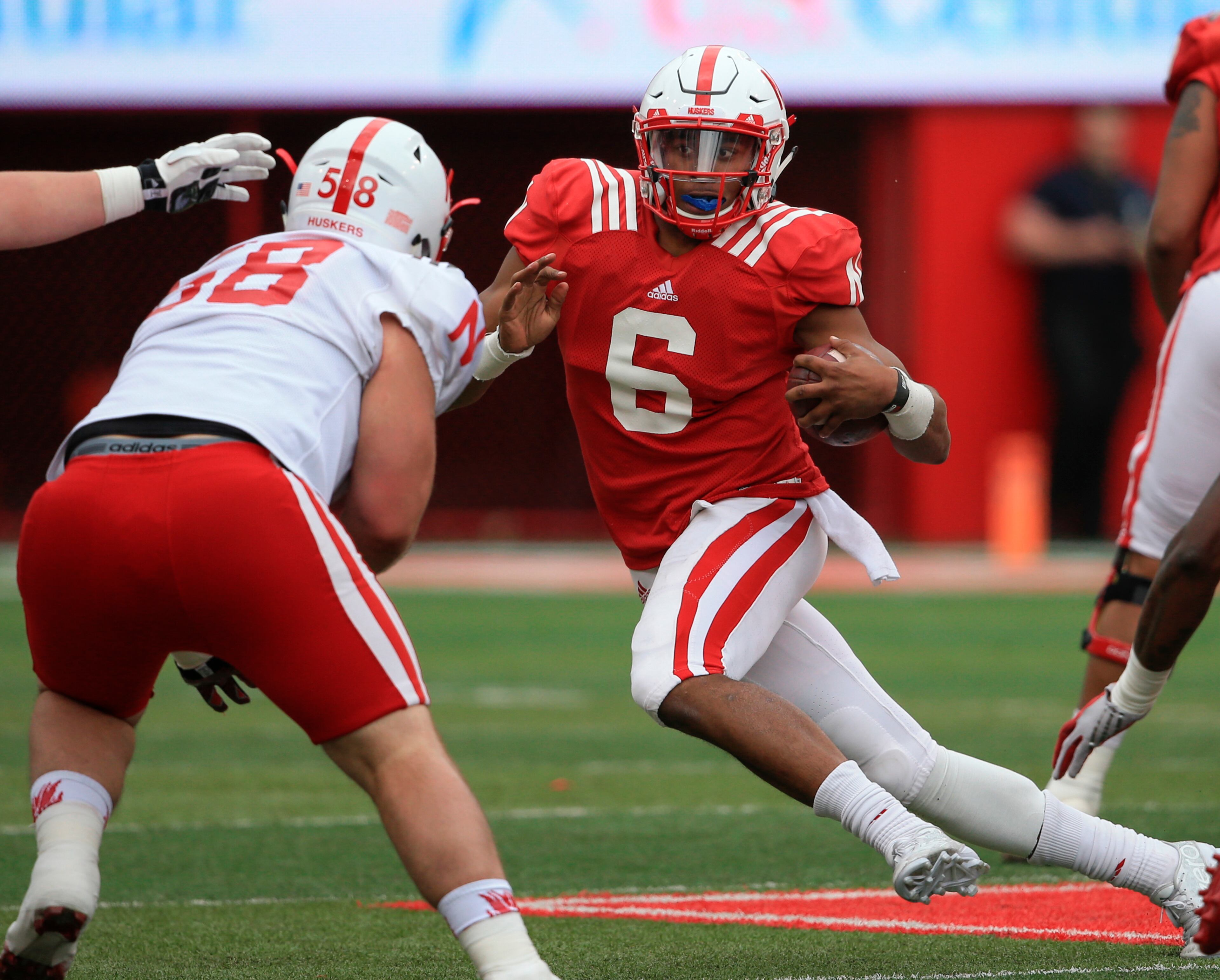 Nebraska red team quarterback AJ Bush (6) carries the ball against white team defensive lineman Joel Lopez (58) during the annual NCAA college football Red White spring game in Lincoln, Neb., Saturday, April 16, 2016. (AP Photo/Nati Harnik)