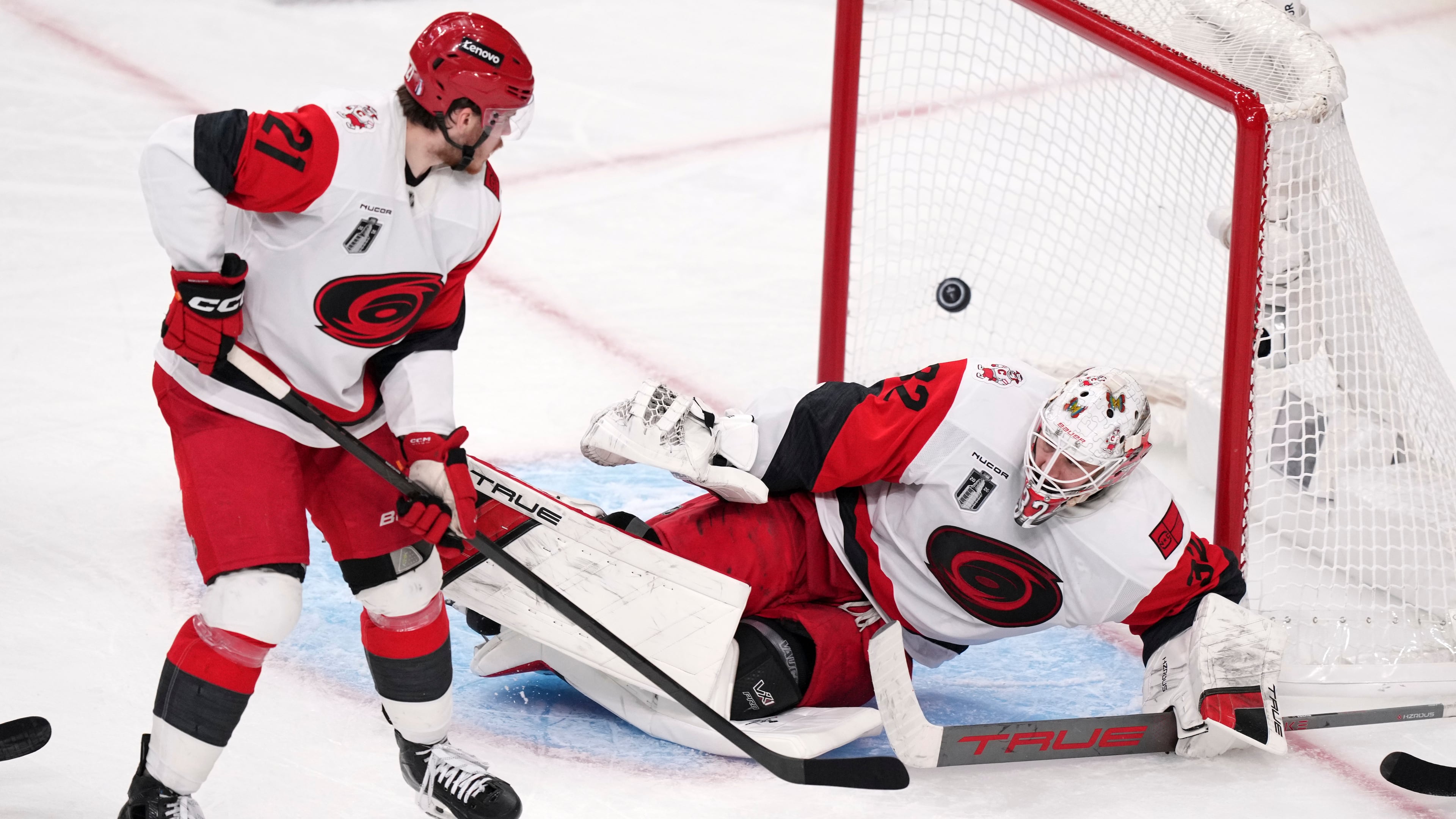 Carolina Hurricanes goaltender Brandon Bussi, right, is scored on by Carolina Hurricanes left wing Nikolaj Ehlers as defenseman Alexander Nikishin watches during the second overtime in Game 3 of the NHL hockey Stanley Cup Final series Saturday, June 6, 2026, in Las Vegas. (AP Photo/Candice Ward)