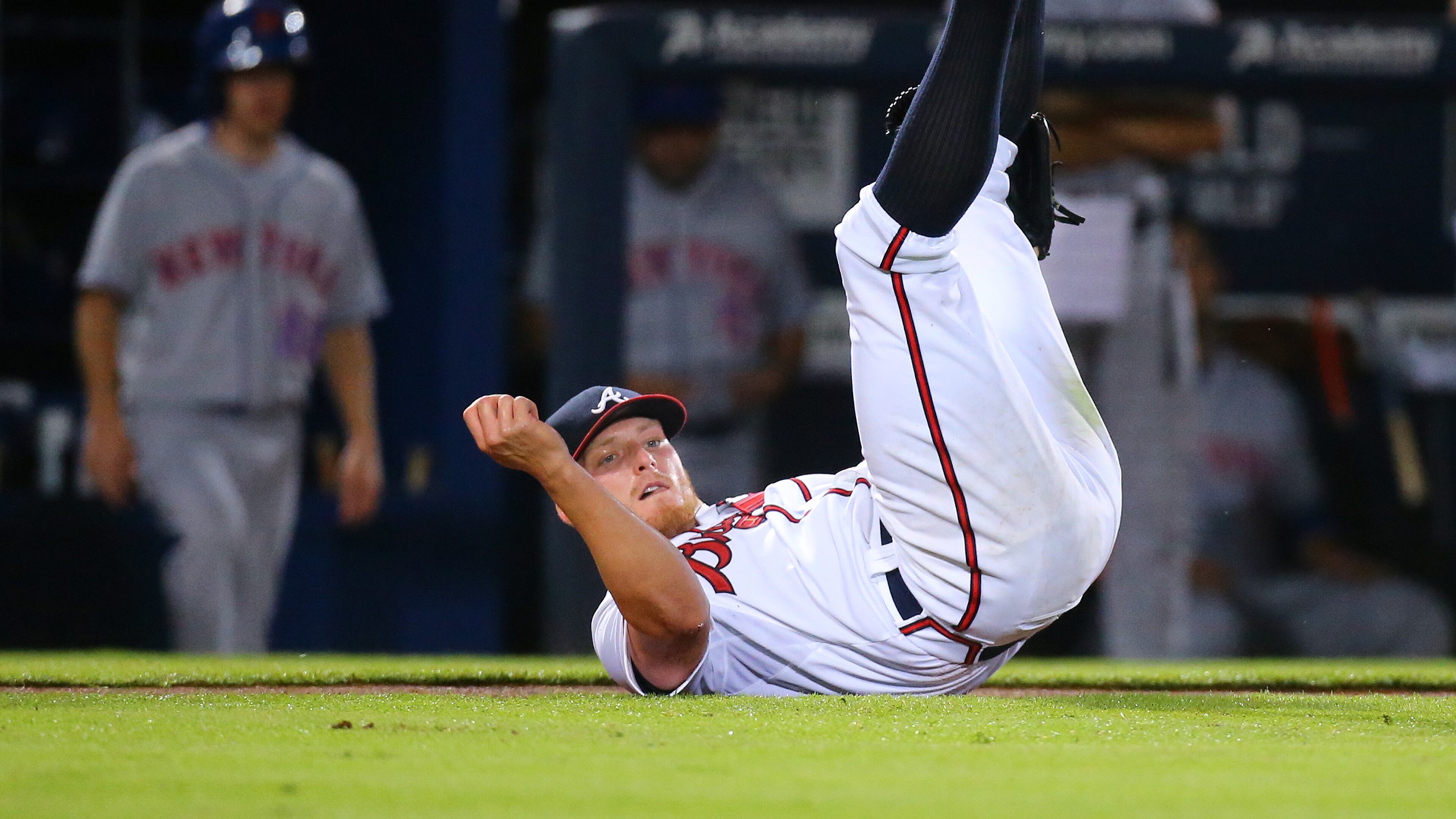 Braves pitcher Shelby Miller hits the ground while fielding a blooper by Mets Kelly Johnson, but the throws not in time as Johnson gets a single during the fourth inning in a baseball game on Thursday, Sept. 10, 2015, in Atlanta. The Mets scored three runs in the inning to take a 3-0 lead. Curtis Compton / ccompton@ajc.com