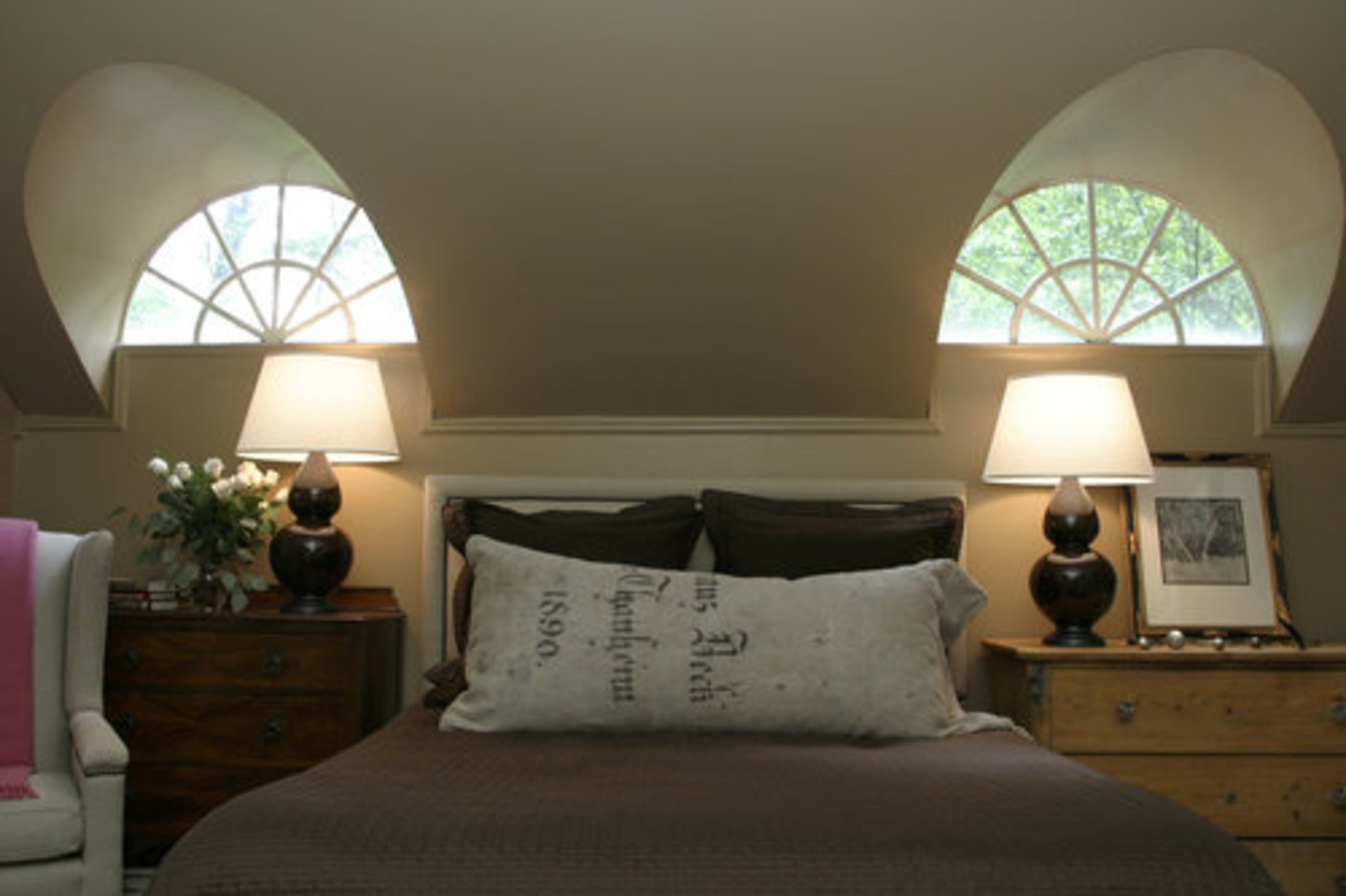 Palladium windows provide a graphic architectural element to the master suite. Another one of Mary's vintage linen grain sacks adds textural contrast to the bedding.