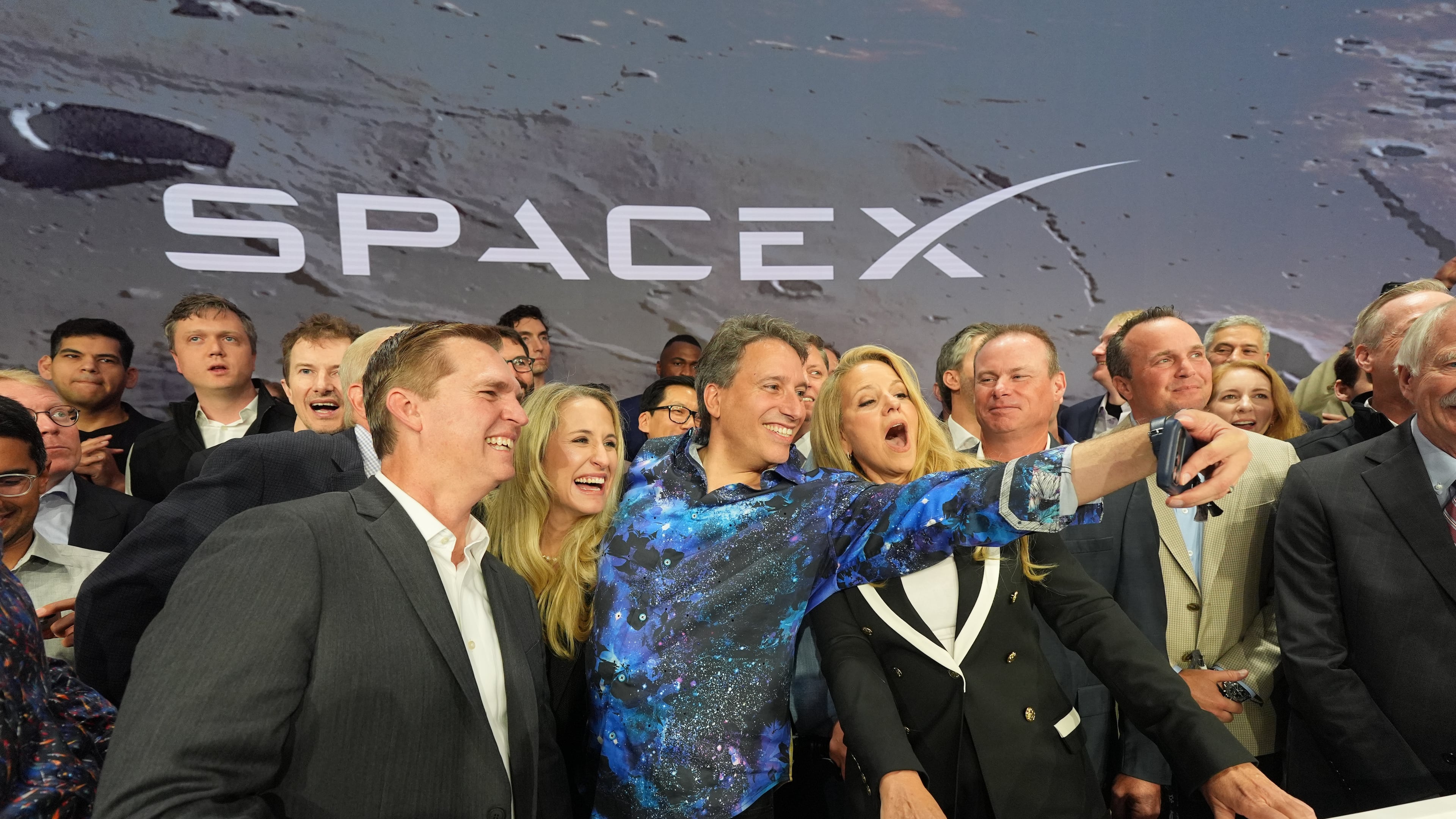 Gwynne Shotwell, President and COO of SpaceX, right, poses with colleagues during a bell ringing ceremony for the IPO of SpaceX at the Nasdaq MarketSite in New York, Friday, June 12, 2026, in New York. (AP Photo/Frank Franklin II)