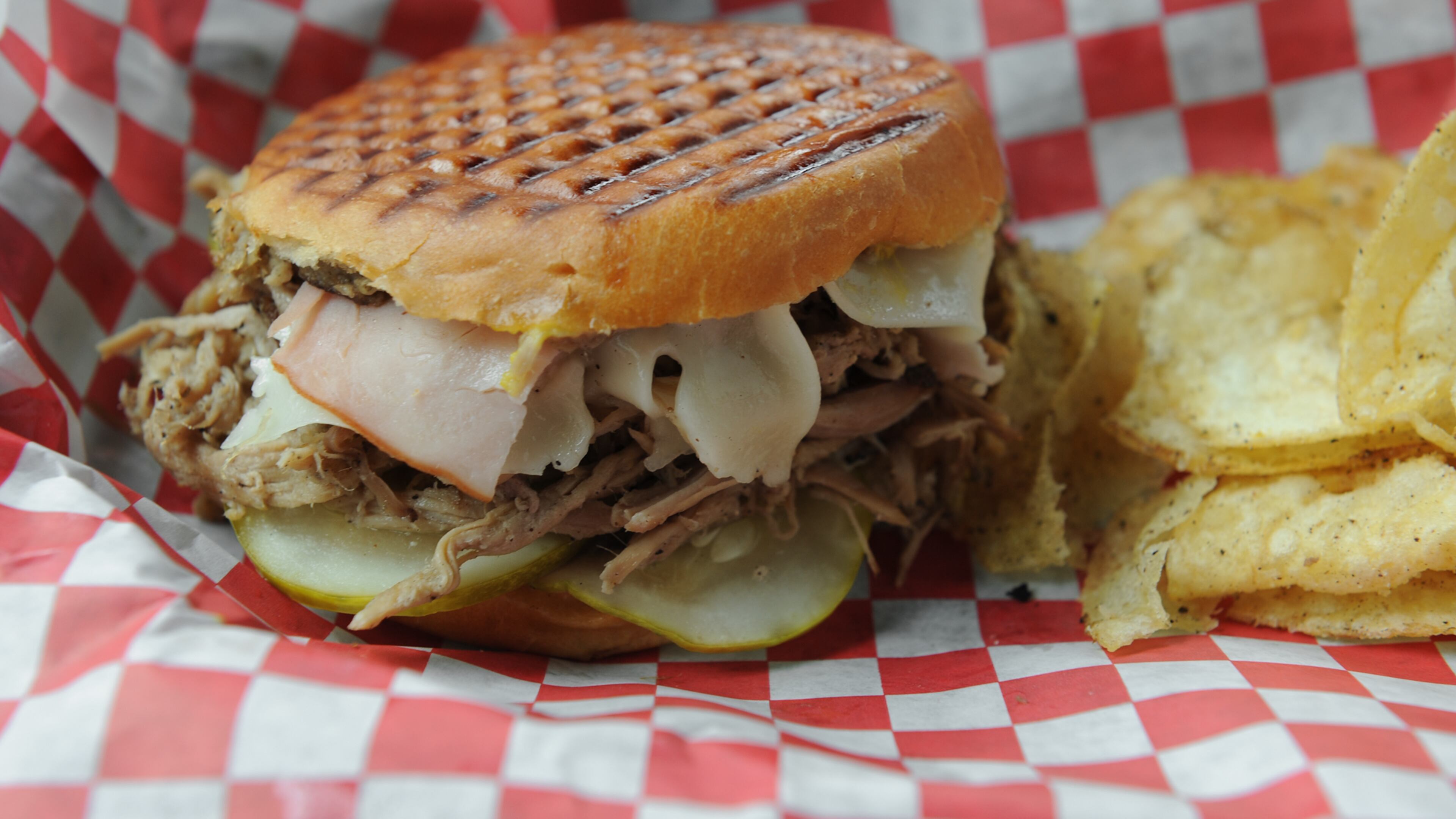 Castro sandwich with Paloma- slow smoked pork ham, fontina cheese, yellow mustard, deli dill pickles pressed on a parker house roll at Victory Sandwich Bar. (Beckysteinphotography.com)