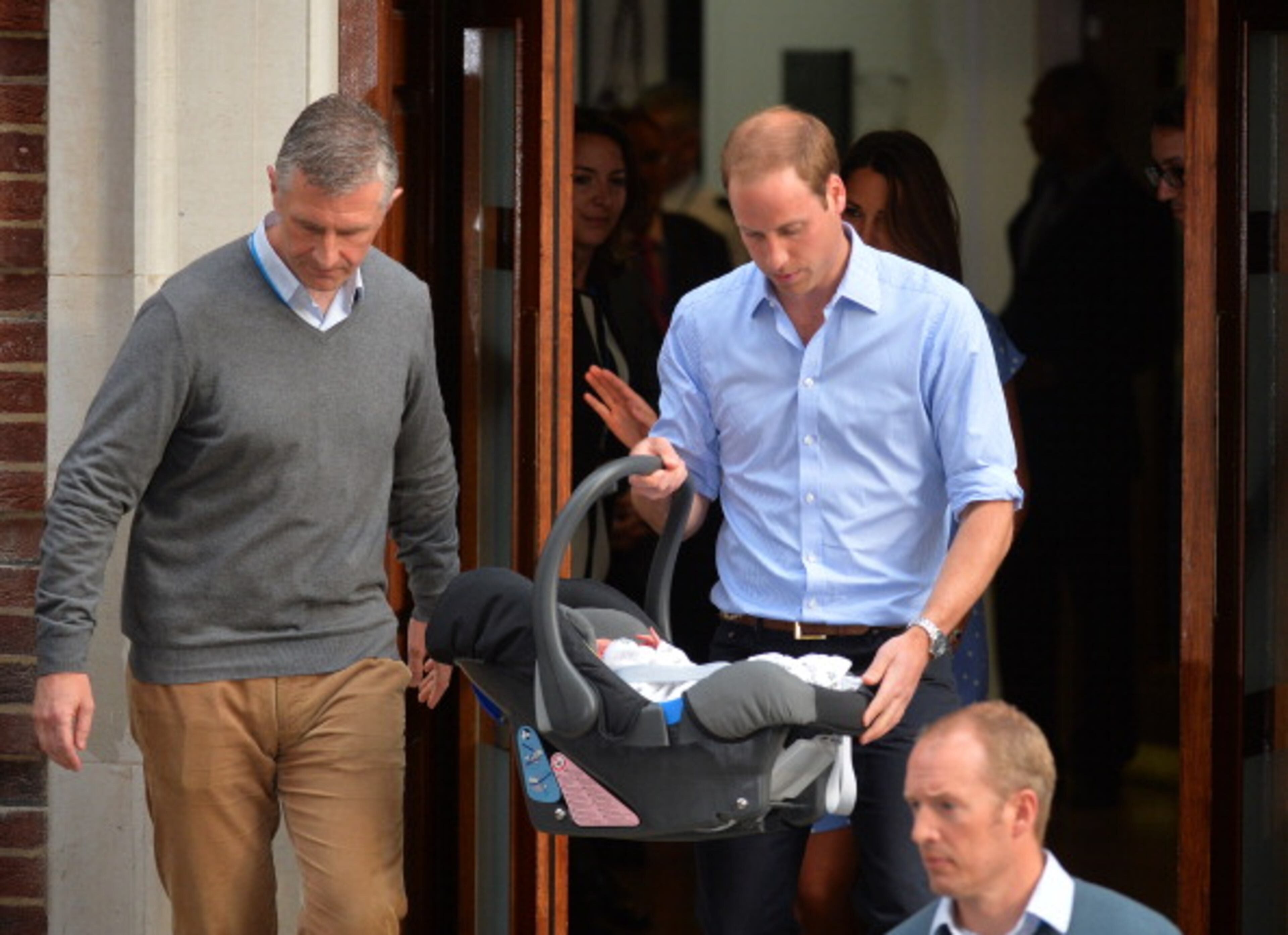 Prince William, the Duke of Cambridge carries his new-born baby boy to the car after showing him to the world's media outside the Lindo Wing of St Mary's Hospital in London on July 23, 2013. The baby was born on Monday afternoon weighing eight pounds six ounces (3.8 kilogrammes). The baby, titled His Royal Highness, Prince (name) of Cambridge, is directly in line to inherit the throne after Charles, Queen Elizabeth II's eldest son and heir, and his eldest son William. AFP PHOTO / LEON NEAL (Photo credit should read LEON NEAL/AFP/Getty Images)