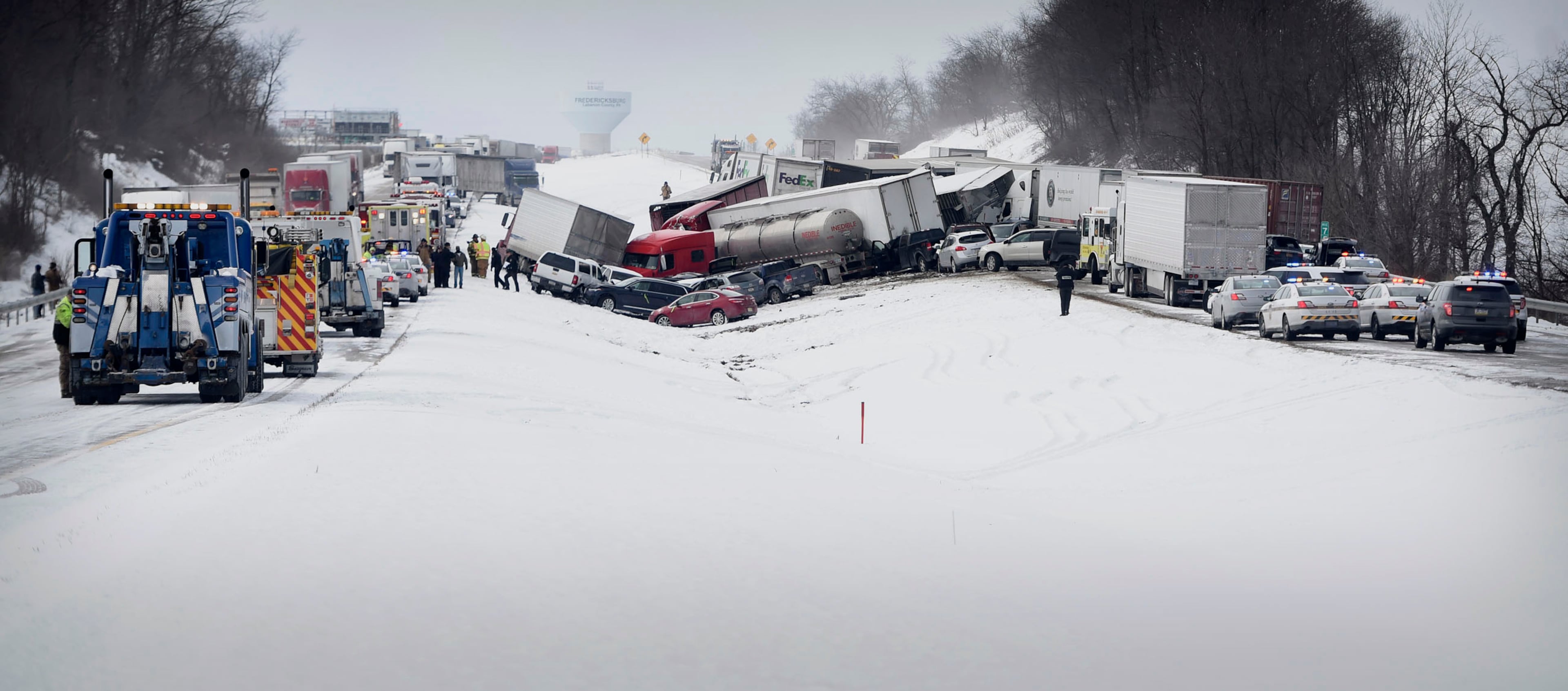 Vehicles pile up after a fatal crash near Fredericksburg, Pa., Saturday, Feb. 13, 2016. The pileup left tractor-trailers, box trucks and cars tangled together across several lanes of traffic and into the snow-covered median. (Michael K. Dakota/Lebanon Daily News via AP)