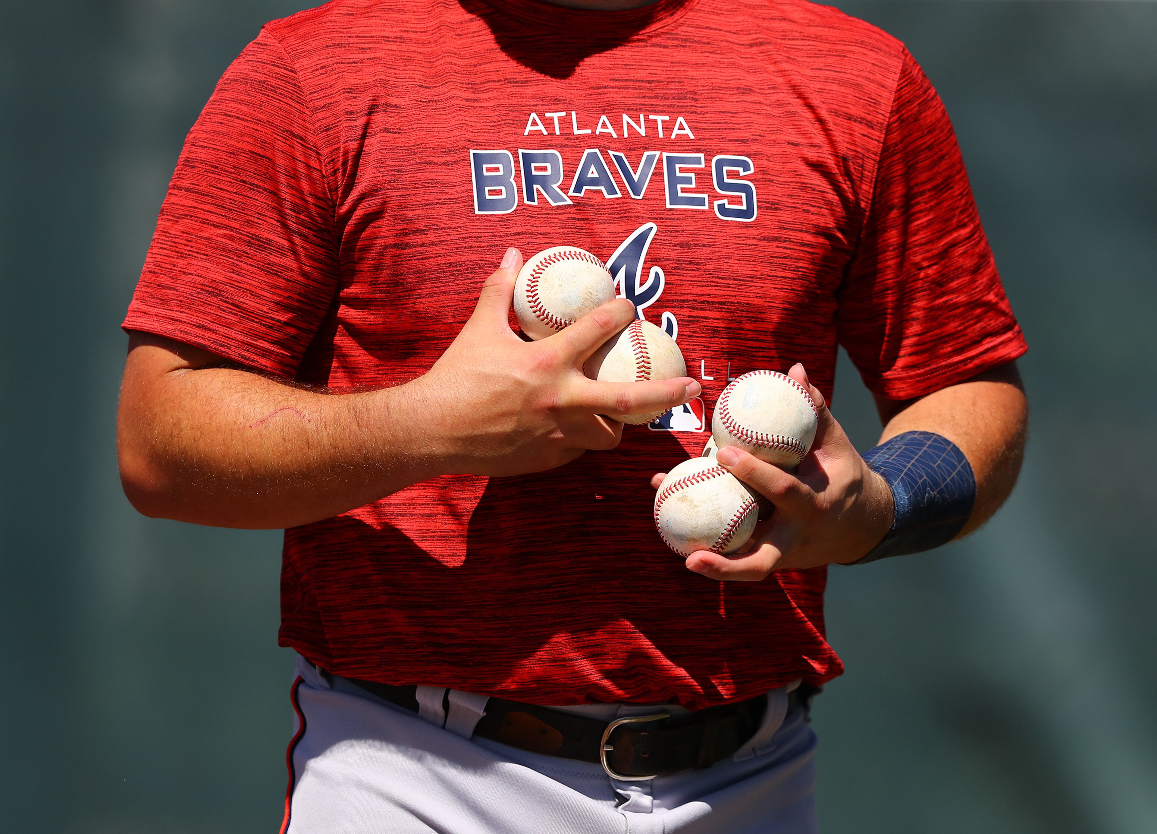 030622 North Port: Atlanta Braves top prospect catcher Shea Langeliers has his hands full of baseballs as he gets in some work on the first day of Braves minor league spring training camp on Sunday, March 6, 2022, in North Port. “Curtis Compton / Curtis.Compton@ajc.com”`
