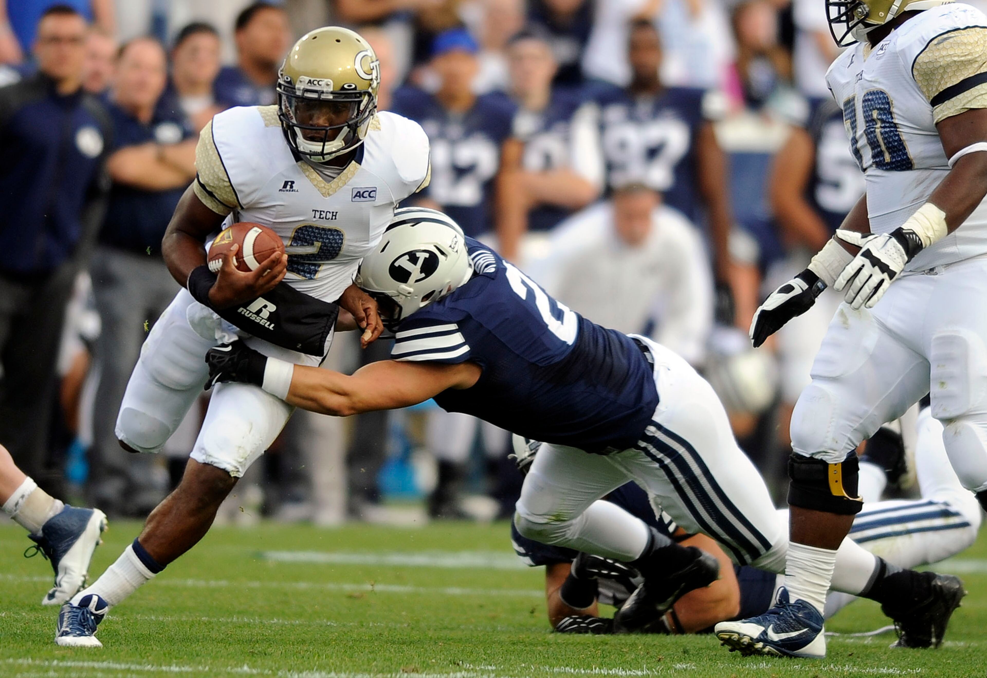 Georgia Tech quarterback Vad Lee (2) is tackled by Brigham Young defensive back Craig Bills (20) during an NCCA college football game, Saturday, Oct. 12, 2013 in Provo, Utah.