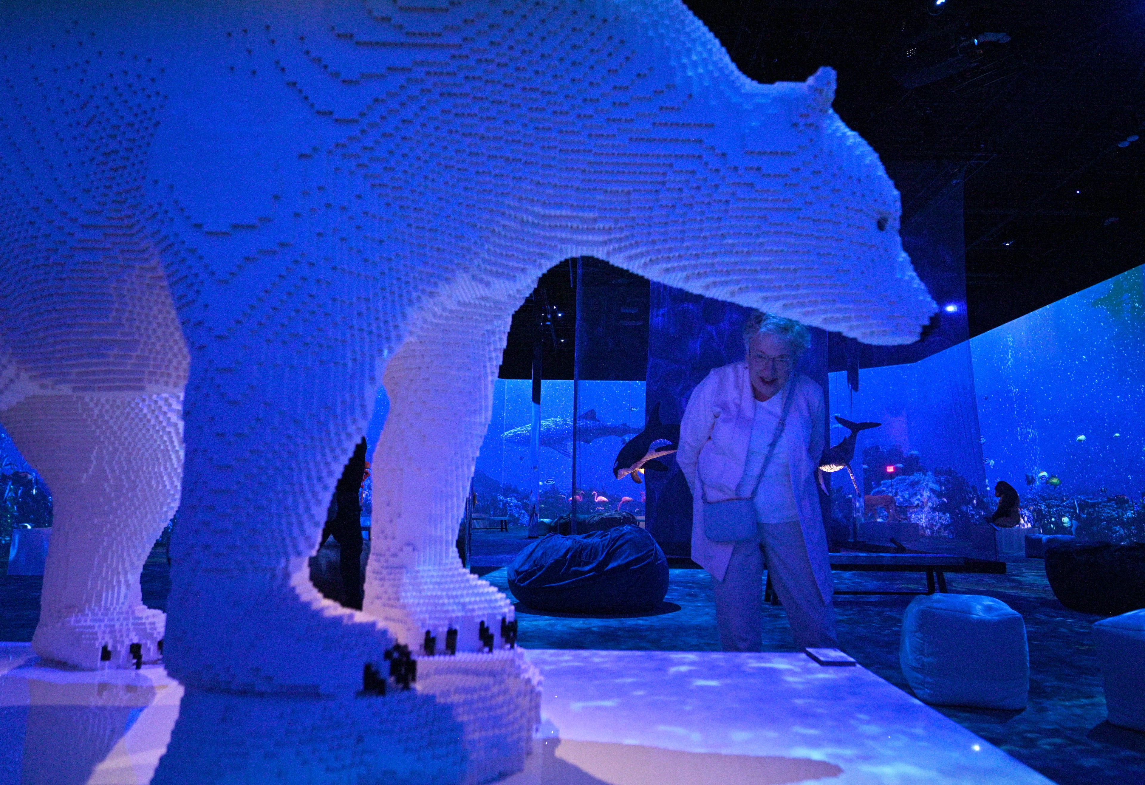 Arlene Shemaka of Woodstock reacts as she looks “Polar Bear and Cub” made with 50,726 bricks at "Art of the Brick Immersive Experience" exhibition at Exhibition Hub Atlanta Art Centre, Wednesday, April 19, 2023, in Doraville. The exhibition will feature many pieces and themes, including a room with oversized sculptures (25-foot long), over 70 works of art crafted from more than 1 million LEGO bricks, galleries celebrating human-kind and nature, and a short documentary about how Nathan creates his works. (Hyosub Shin / Hyosub.Shin@ajc.com)
