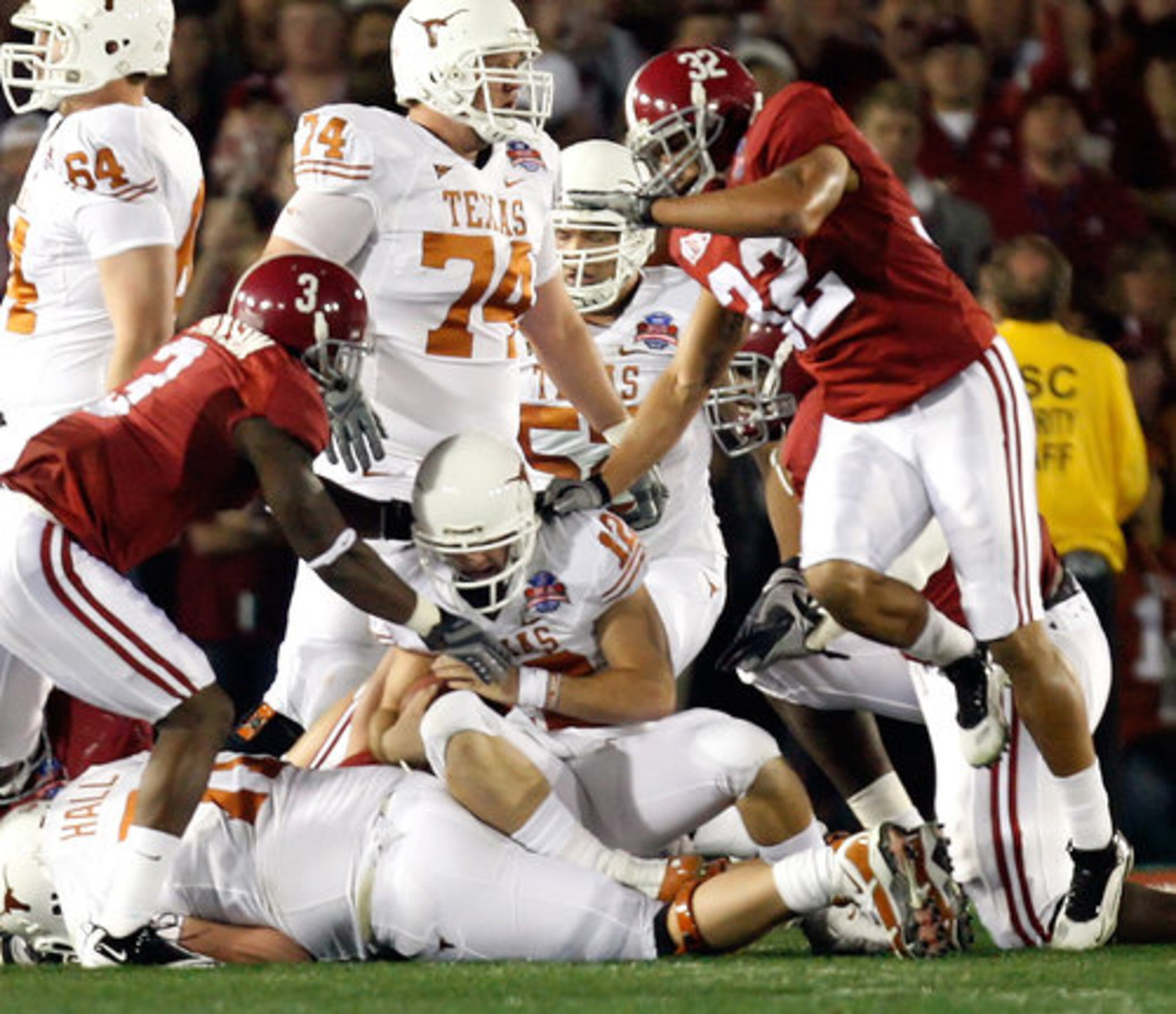 Texas quarterback Colt McCoy (12) is injured as he absorbs a hit from the Alabama defense during first-half action in the BCS National Championship game in Pasadena, California on Thursday,.