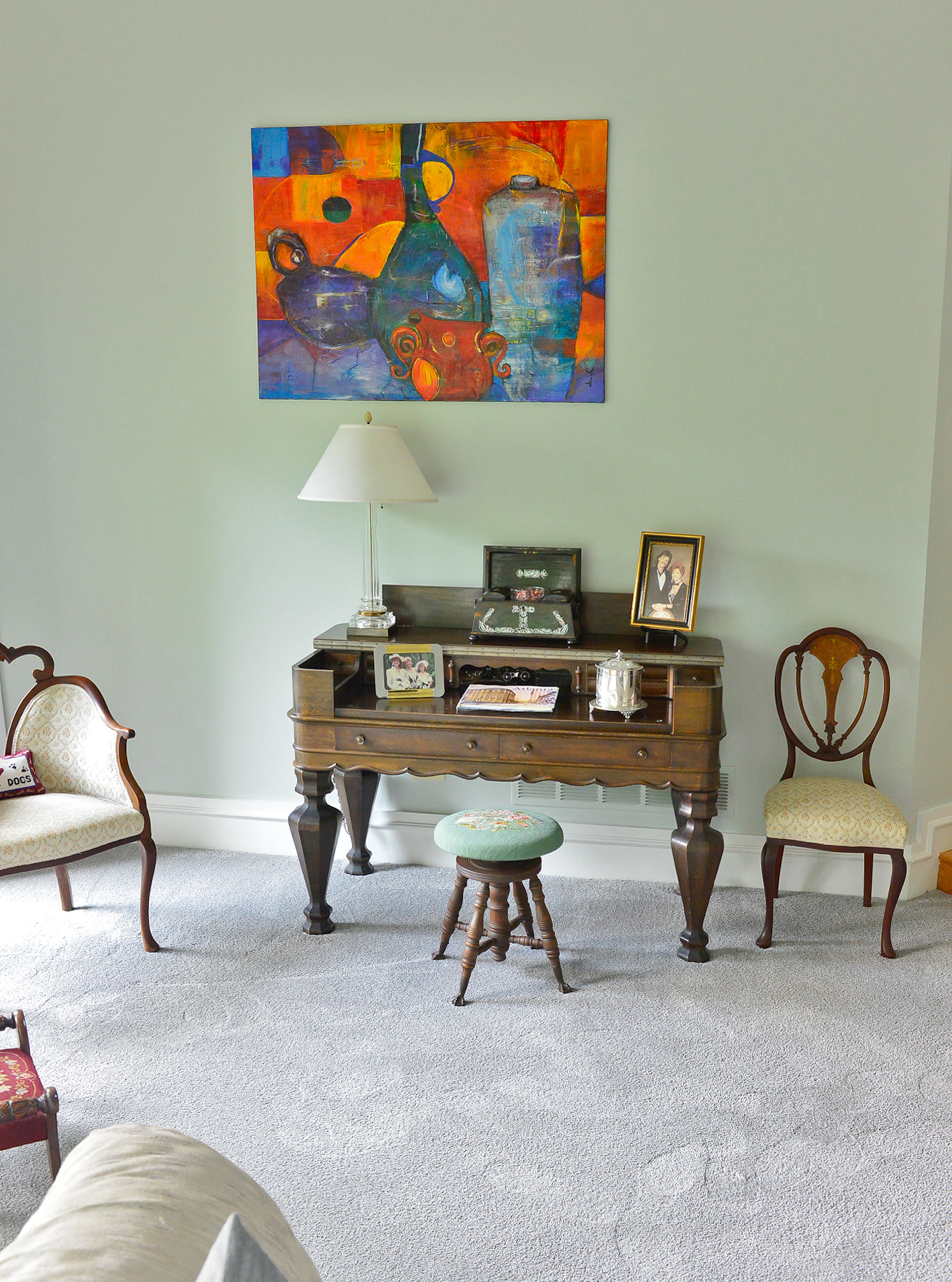 Rosewood antique chairs with mahogany and walnut accents flank a mahogany desk that once belonged to homeowner Judy Mozen’s grandfather. A closer look reveals the desk was actually crafted out of a piano, which inspired its unique, bold style.
