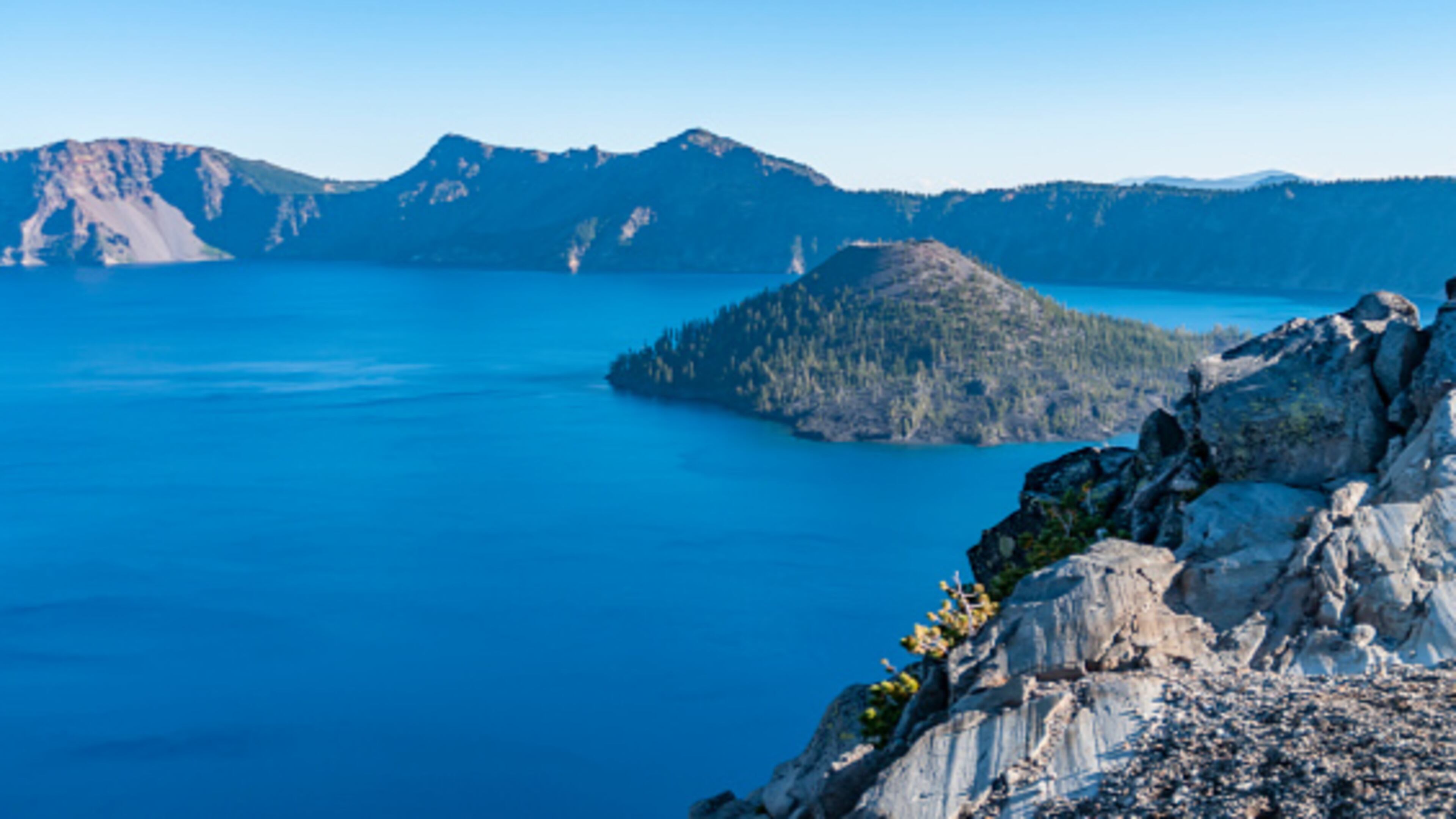 View of Wizard Island, a volcanic cinder cone which forms an island at the west end of Crater Lake in Crater Lake National Park, Oregon.