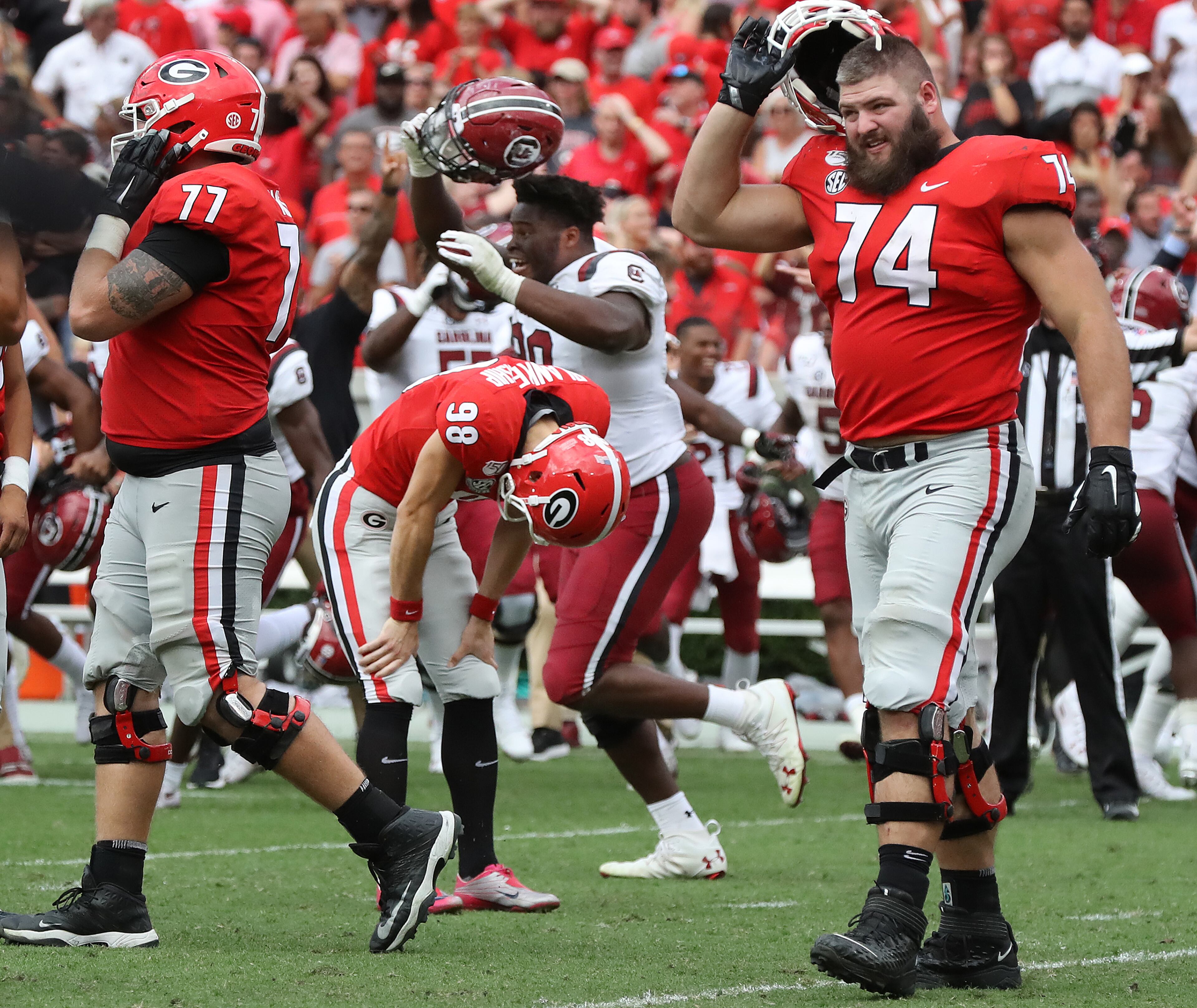Georgia kicker Rodrigo Blankenship bends over dejectedly, reacting to missing his field goal attempt in double overtime as the Bulldogs lost to South Carolina 20-17 Saturday in Athens. Curtis Compton/ccompton@ajc.com