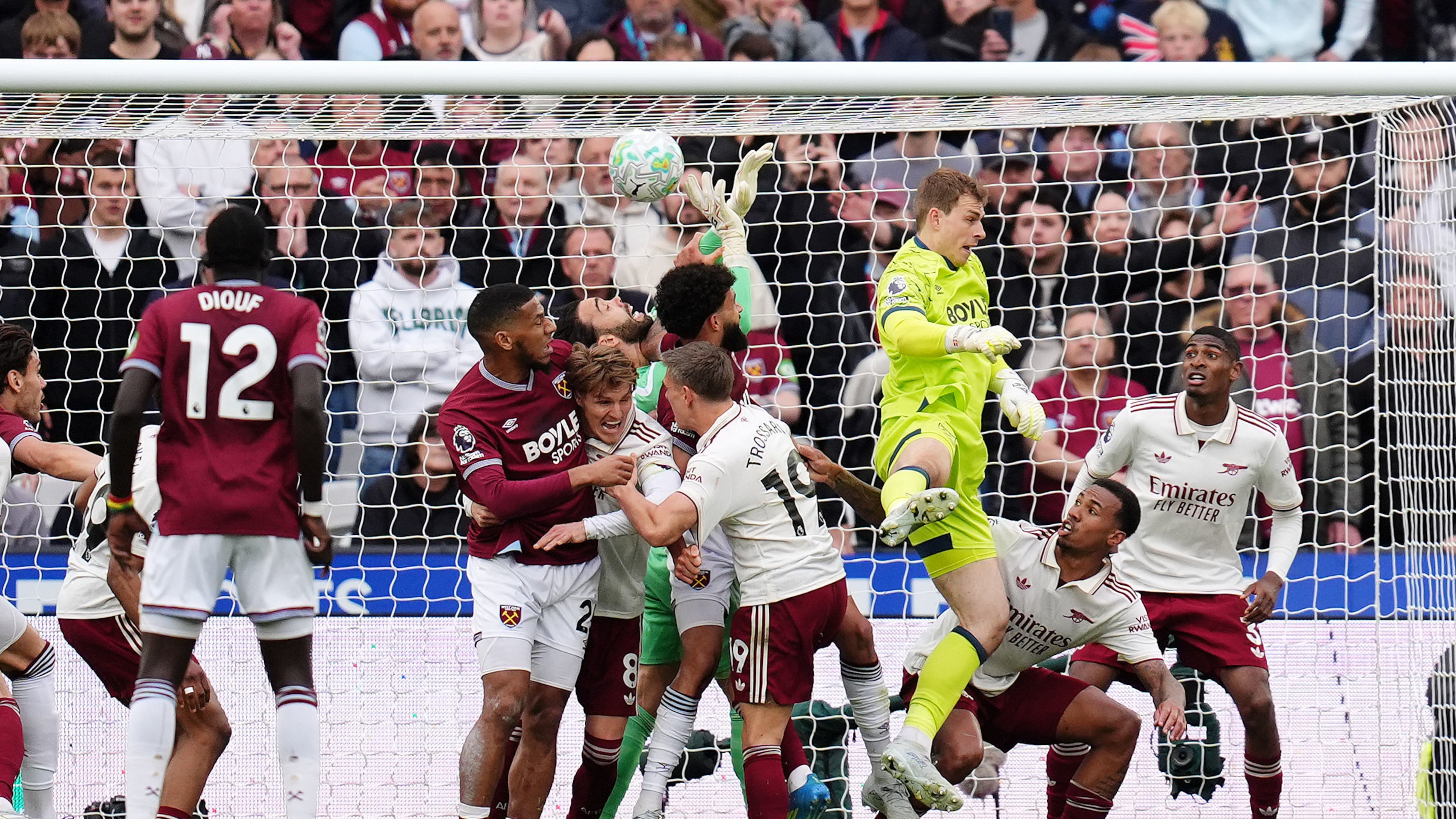 Arsenal goalkeeper David Raya, center, is fouled by West Ham United's Pablo Felipe in the build up to Callum Wilson disallowed goal during the English Premier League match in London, Sunday May 10, 2026. (John Walton/PA via AP)