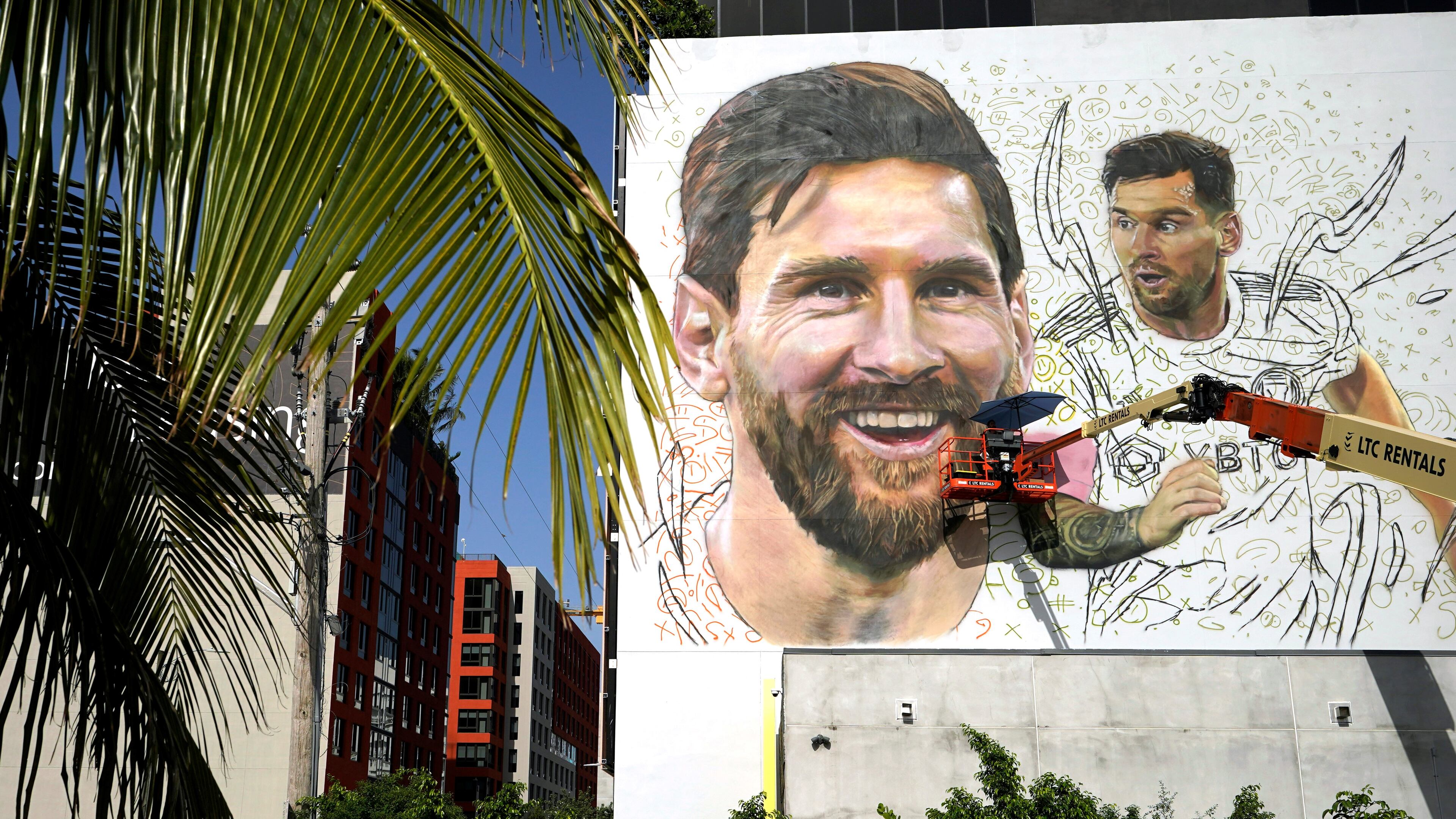 Artist Maximiliano Bagnasco paints a mural of Argentine soccer star Lionel Messi, Monday, July 10, 2023, in the Wynwood neighborhood of Miami. Murals, burgers, beers, and billboards are just a handful of examples that show the euphoria that Messi generates in South Florida and how he will be received when he lands for his new stage as a player with the Major League Soccer team Inter Miami. (AP Photo/Lynne Sladky)