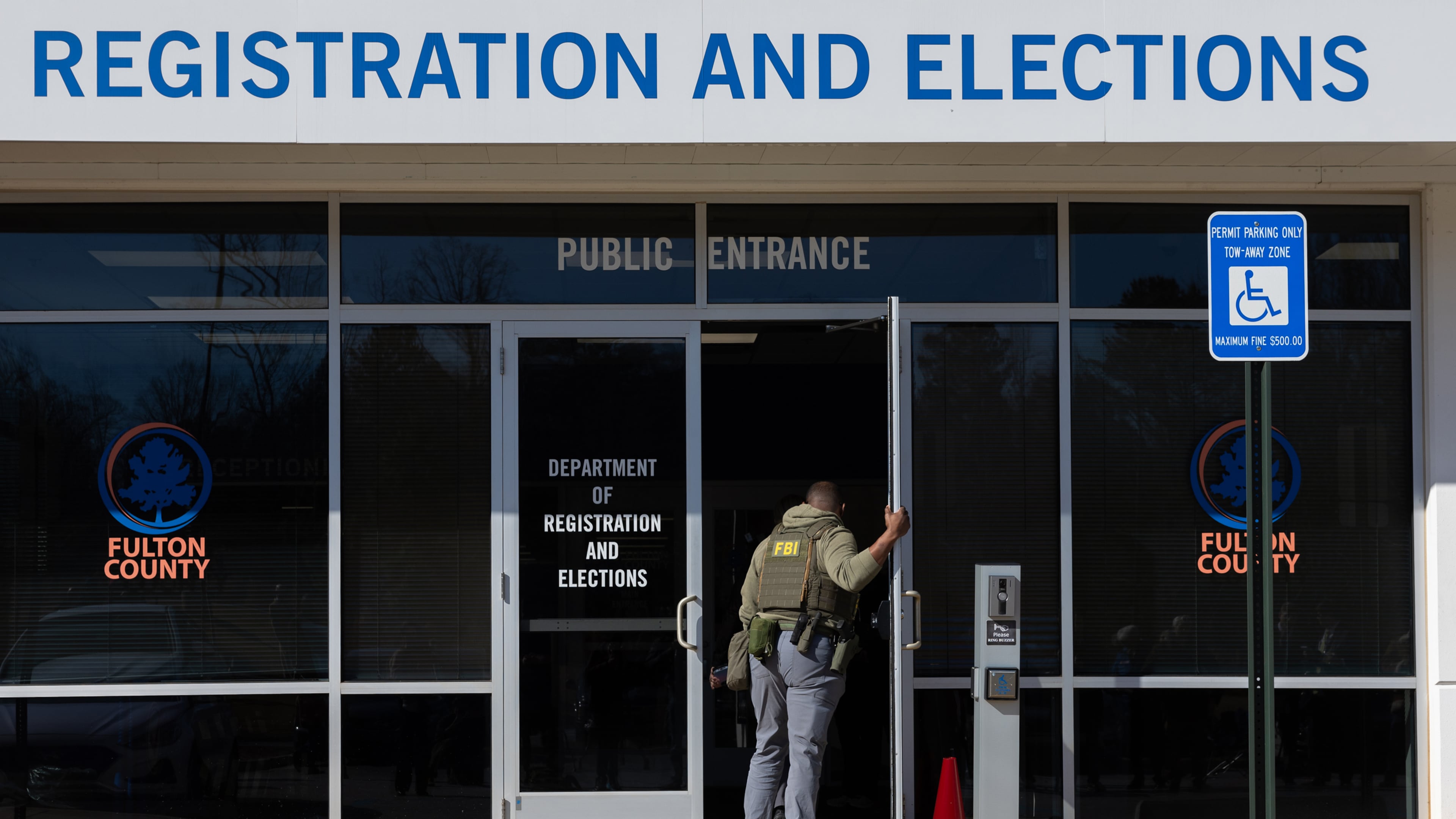 FBI agents enter the Fulton County Election Hub and Operation Center in Union City this past January. (Arvin Temkar/AJC)