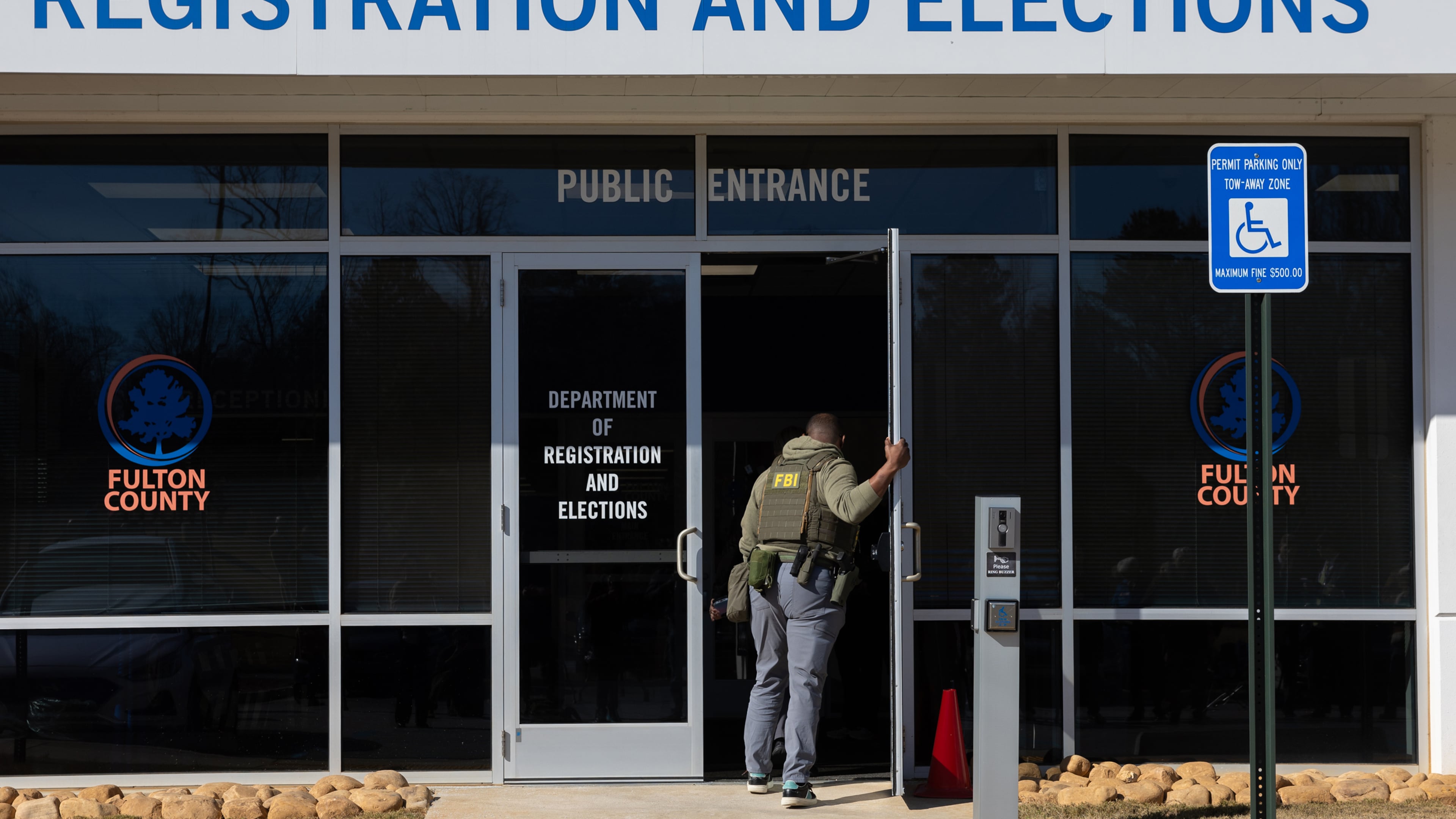 FBI agents enter the Fulton County Election Hub and Operation Center in Union City on Jan. 28. (Arvin Temkar/AJC)