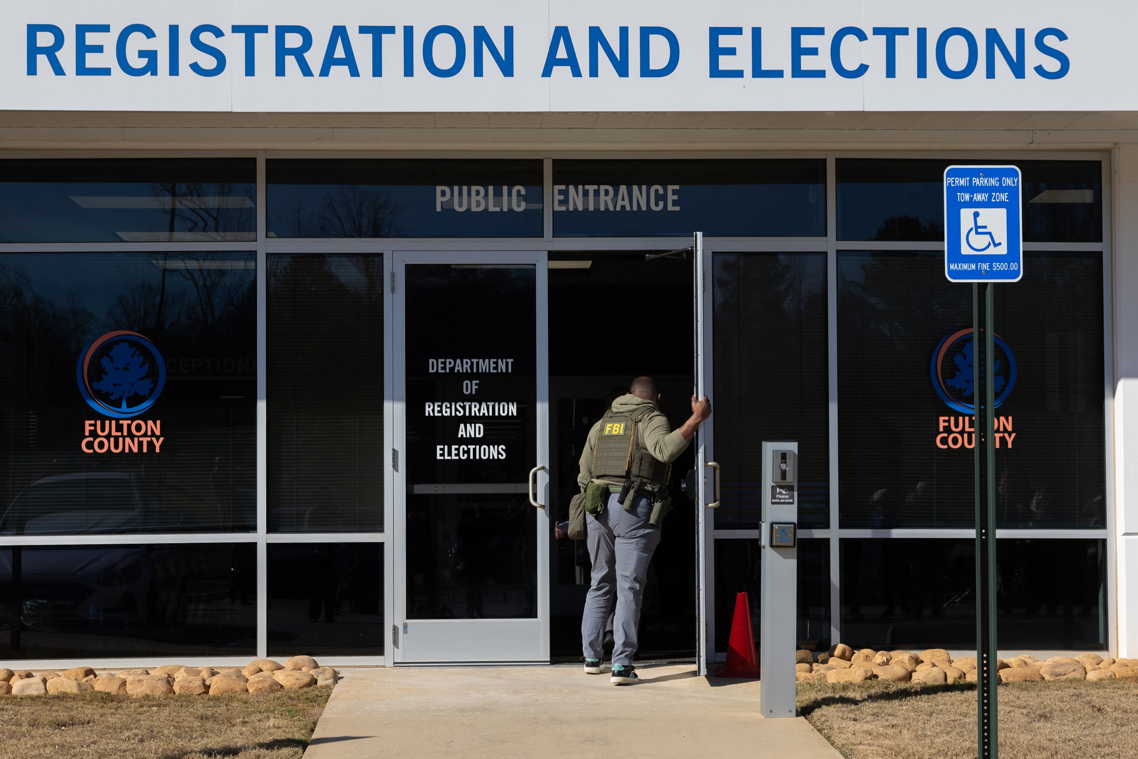 FBI agents enter the Fulton County Election Hub and Operation Center in Union City this past January. (Arvin Temkar/AJC)