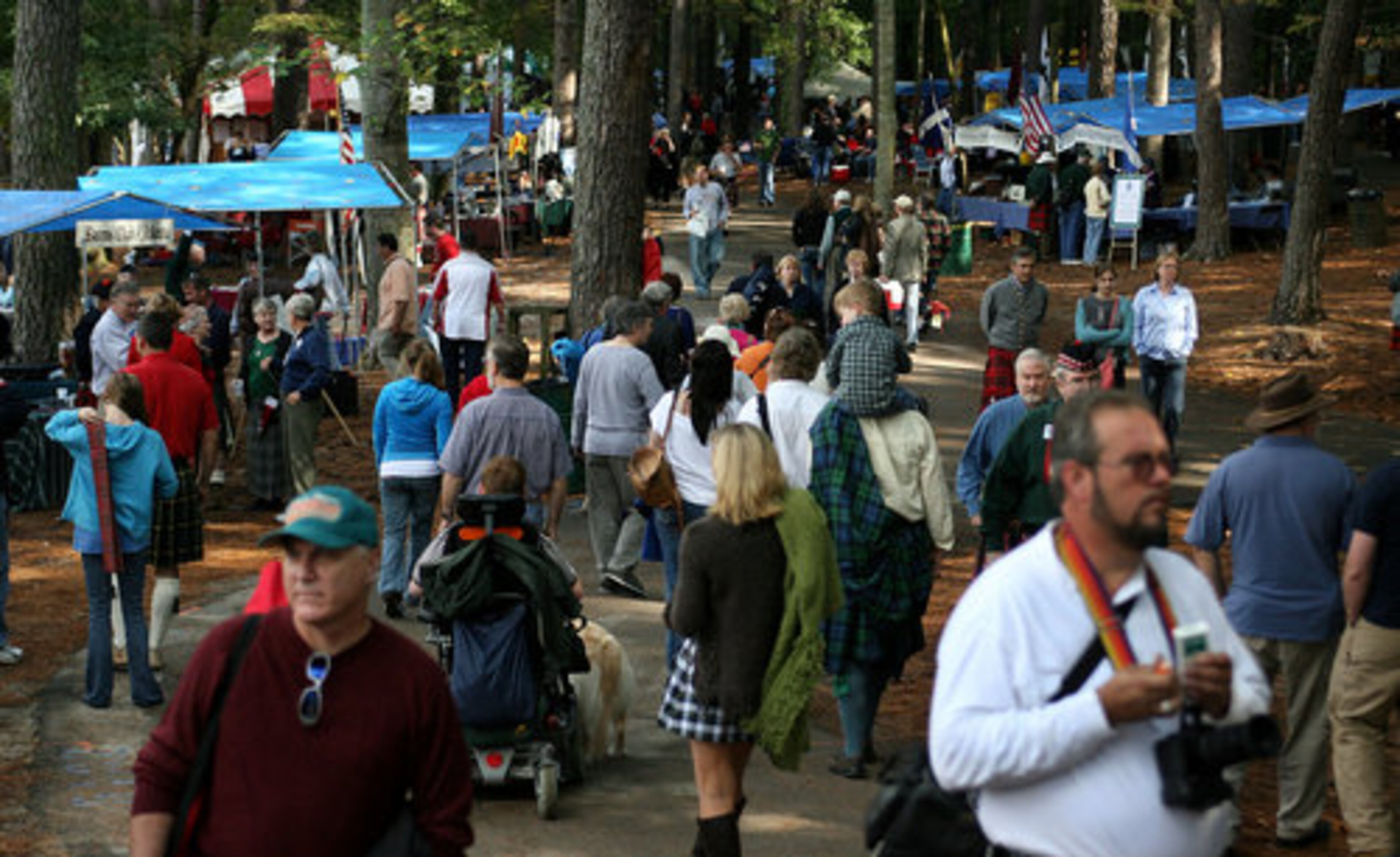 Visitors explore the booths and clan tents at the festival in Stone Mountain Park on Saturday.