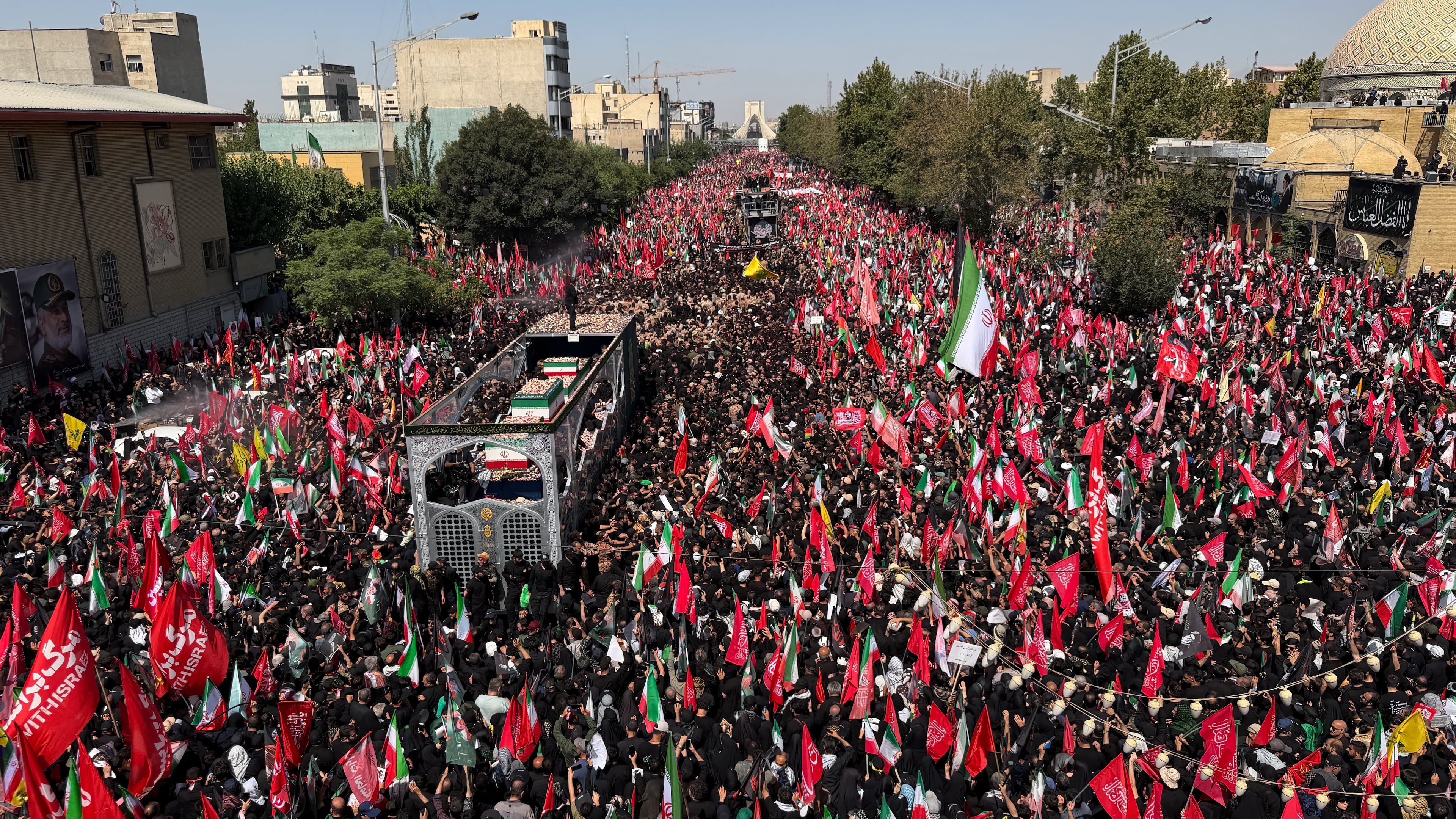 A truck carrying the coffins of the late Iranian Supreme Leader Ayatollah Ali Khamenei and members of his family makes its way through mourners during the funeral procession in Tehran, Iran, Monday, July 6, 2026. (AP Photo/Vahid Salemi)