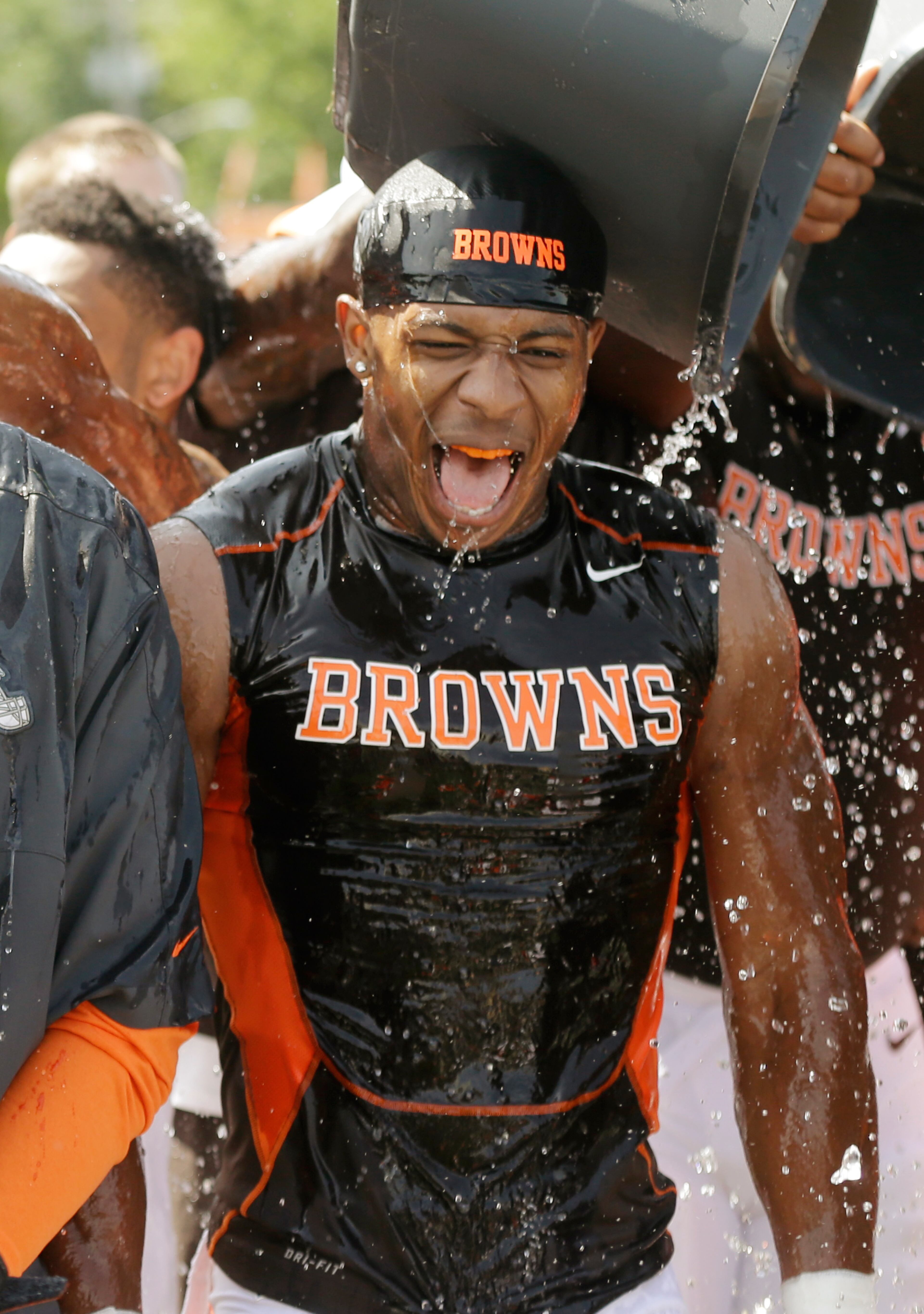 Cleveland Browns cornerback Justin Gilbert reacts after getting ice dumped on him following practice at NFL football training camp in Berea, Ohio Friday, Aug. 15, 2014. The Browns were challenged by the Baltimore Ravens to take the ALS Ice Bucket Challenge, to raise awareness about amyotrophic lateral sclerosis, also known as Lou Gehrig�s Disease. (AP Photo/Mark Duncan)