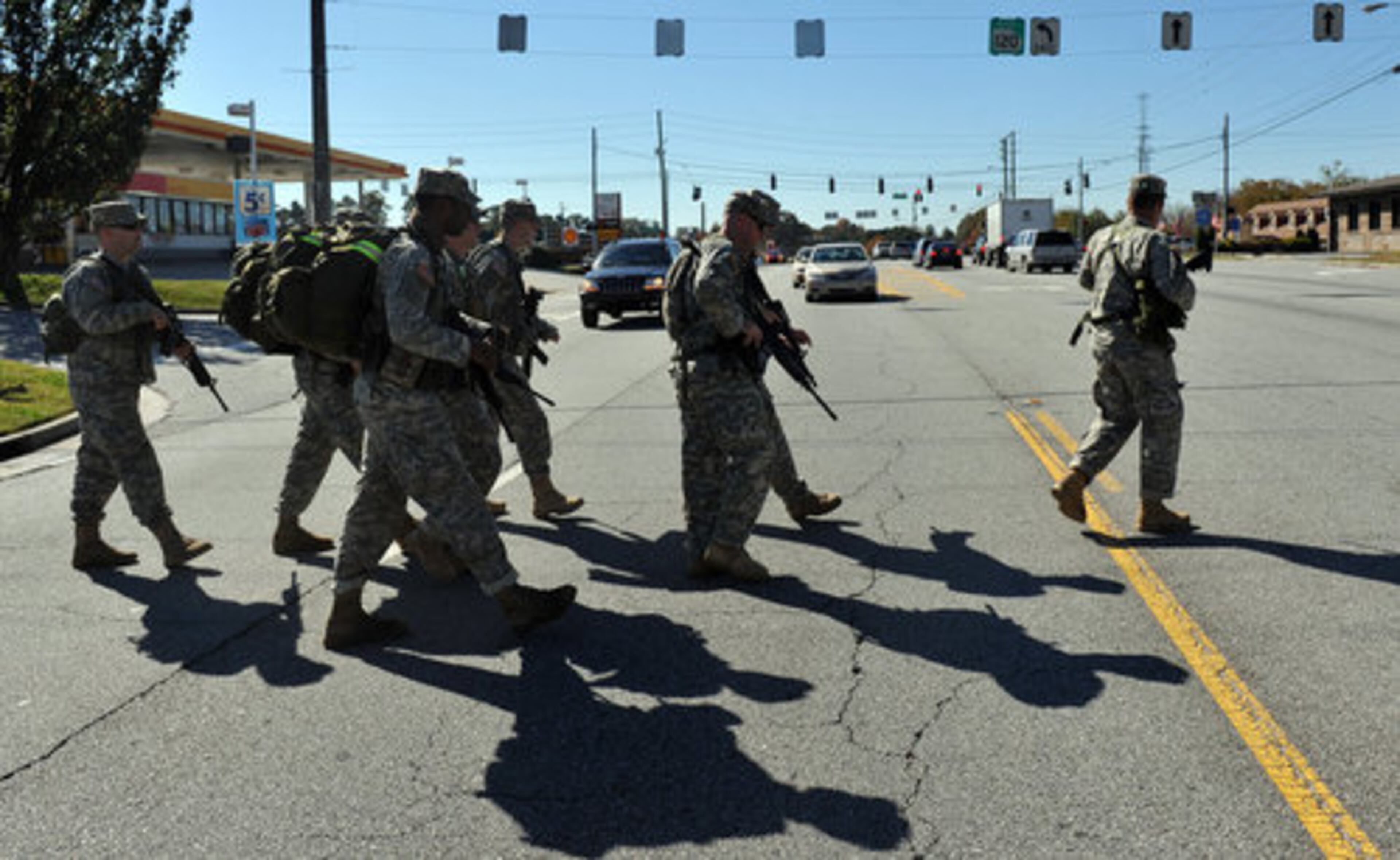 The soldiers cross Buford Highway after a rest stop along their 100-plus mile march to Atlanta from Toccoa, Ga.
