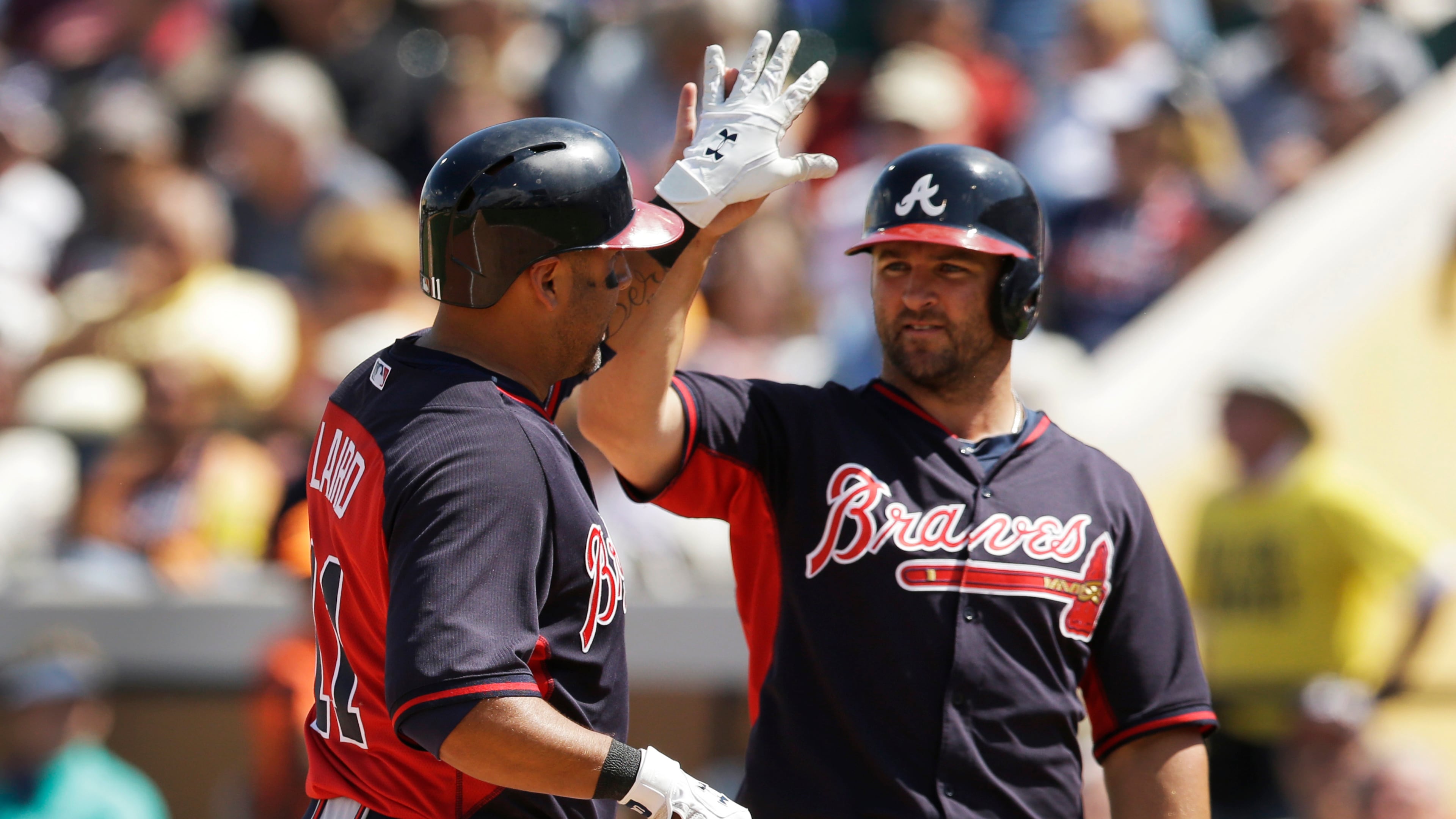 Atlanta Braves' Gerald Laird, left, is congratulated by teammate Dan Uggla after they both scored on Laird's two-run home run during the sixth inning of a spring exhibition baseball game against the Detroit Tigers in Lakeland, Fla., Tuesday, March 25, 2014. (AP Photo/Carlos Osorio)