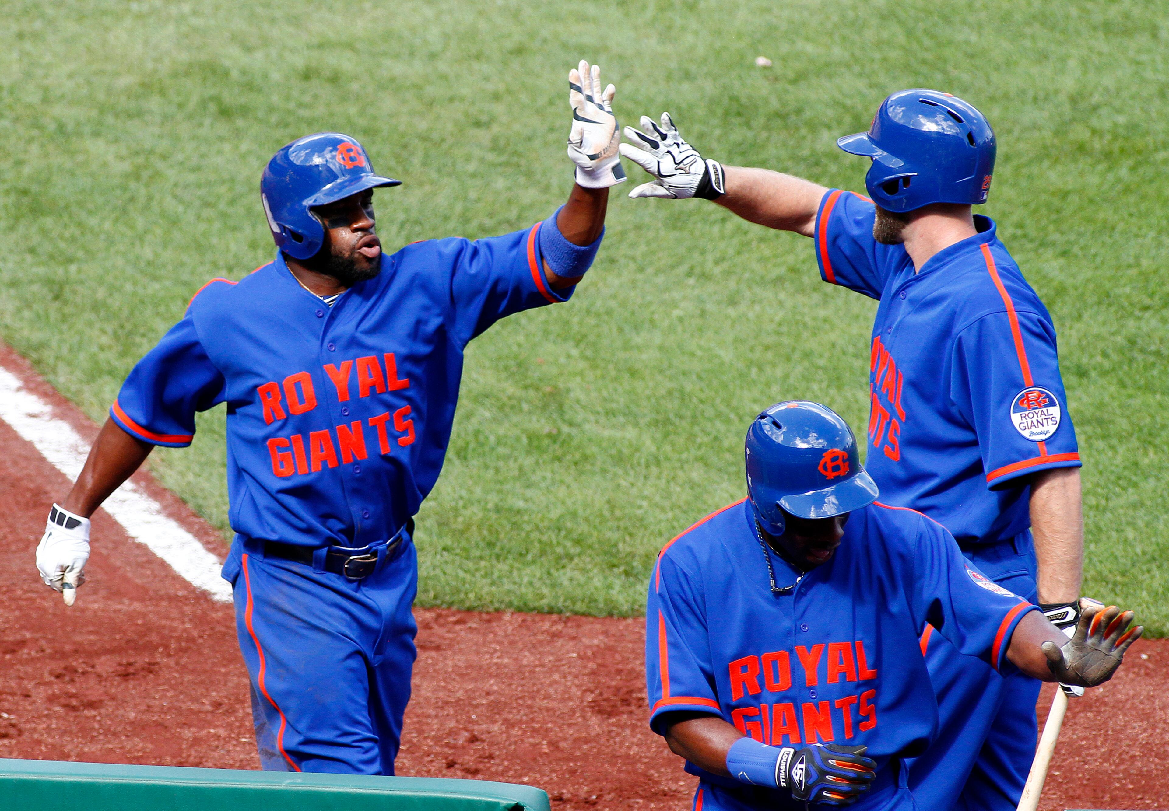 Eric Young Jr. (left) of the New York Mets celebrates with Eric Campbell after scoring on a two RBI single in the second inning against the Pittsburgh Pirates during the game at PNC Park on June 28, 2014 in Pittsburgh. The Mets and the Pirates wear Negro League uniforms as a tribute to the Negro Leagues during a Negro League Heritage Game. The Mets wear uniforms honoring the Brooklyn Royal Giants and the Pirates honor the Pittsburgh Crawfords. (Photo by Justin K. Aller/Getty Images)