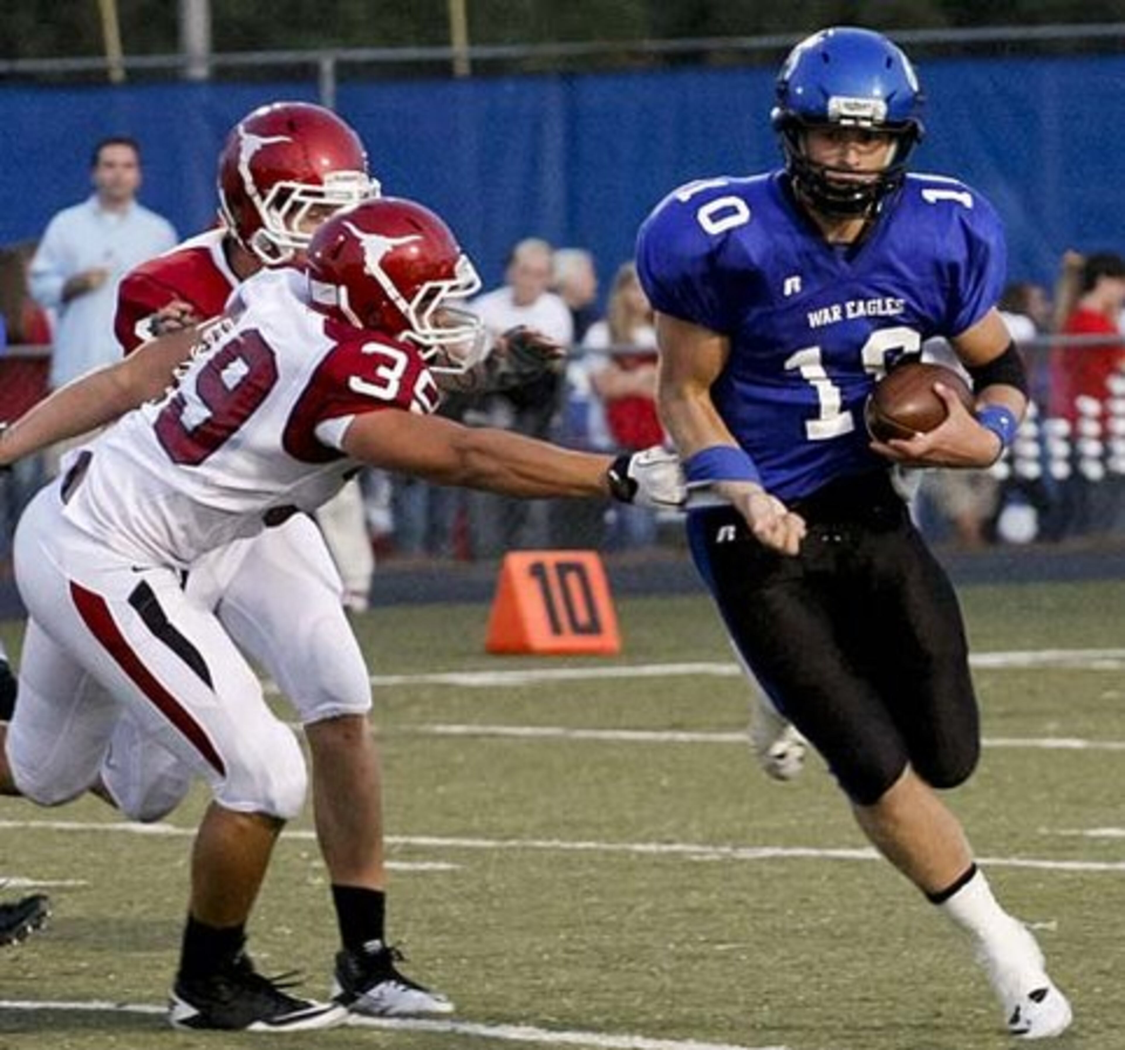 South Forsyth QB Jantzen Jeffrey (10) barely squeezes out of a blitz by Lambert's defense.