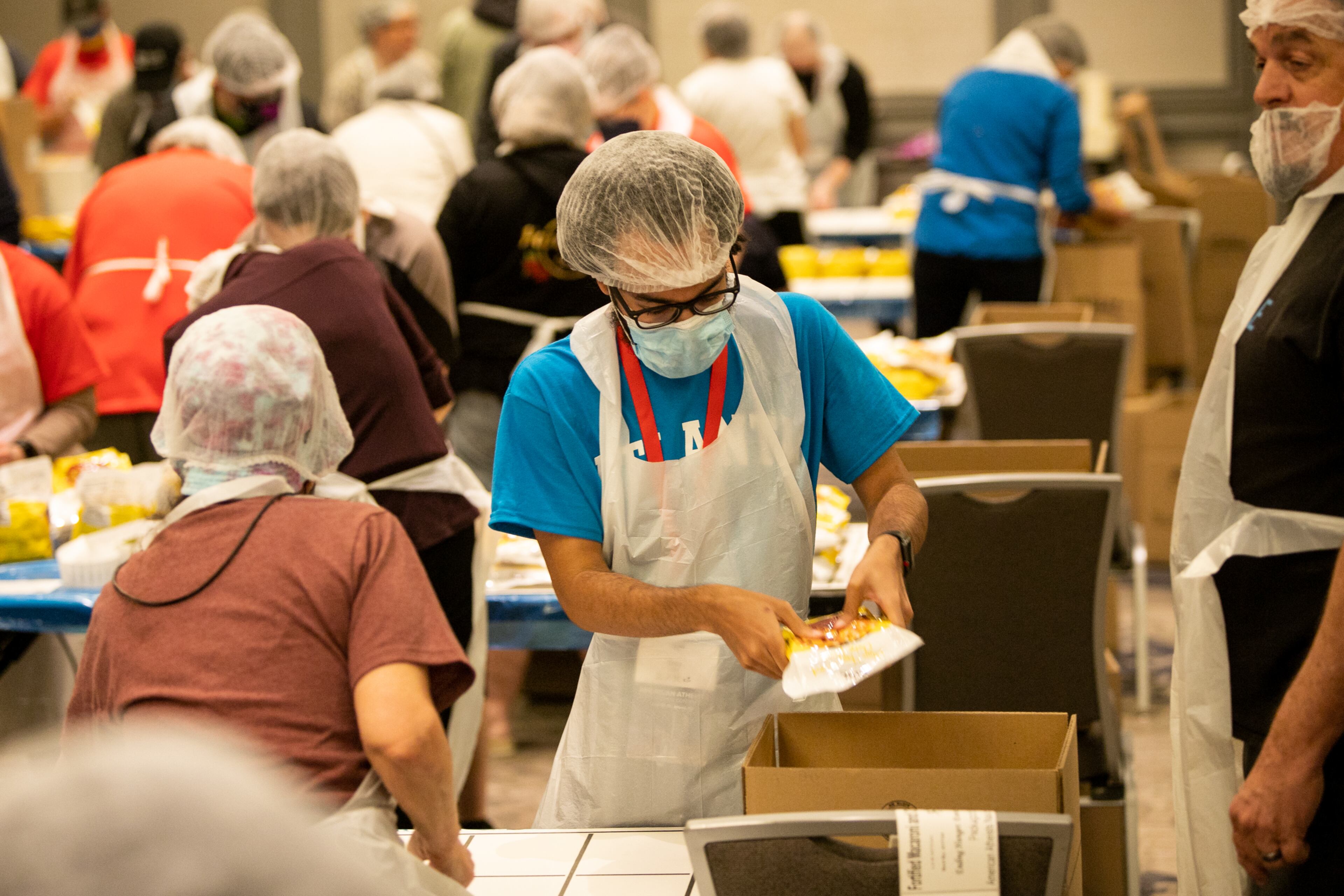 Volunteers, including Trey Trent of Virginia, package mac and cheese dinners for Atlanta charities on Sunday, April 17, 2022, after the formal closing of the American Atheists 2022 National Convention at the Renaissance Waverly Hotel at Cobb Galleria. The group’s goal was to prepare 50,000 servings of protein-filled dinners for those in need in Atlanta. (Photo: Jenni Girtman for The Atlanta Journal-Constitution)