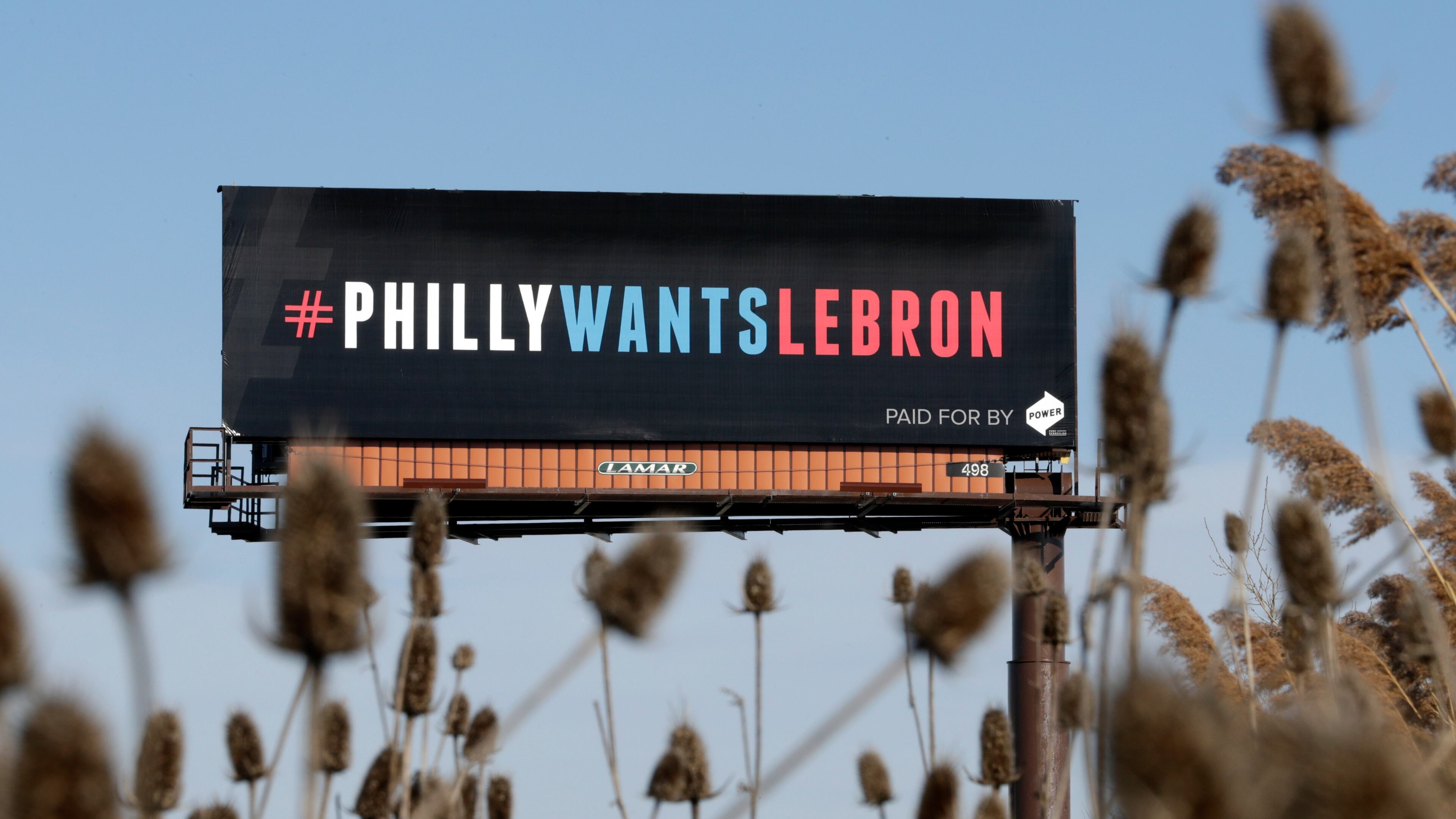 FILE - One of three billboards trying to entice Cleveland Cavaliers' LeBron James to come to Philadelphia are shown near a highway, Tuesday, Feb. 27, 2018, in Cleveland. (AP Photo/Tony Dejak, File)