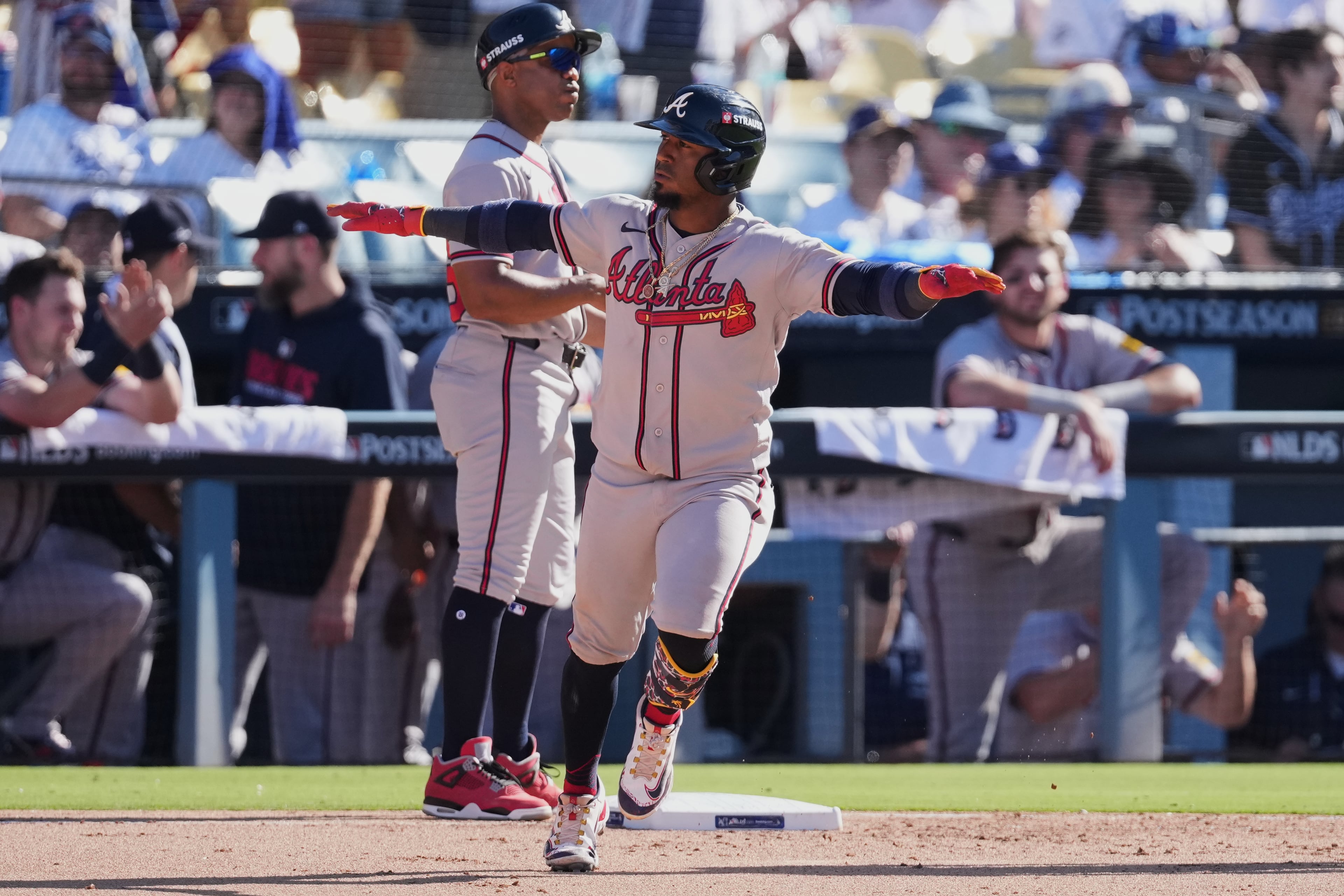 Atlanta Braves' Ozzie Albies celebrates after hitting a two-run home run during the ninth inning of Game 1 of a National League Division Series baseball game against the Los Angeles Dodgers Saturday, Oct. 3, 2026, in Los Angeles. (AP Photo/Jae C. Hong)