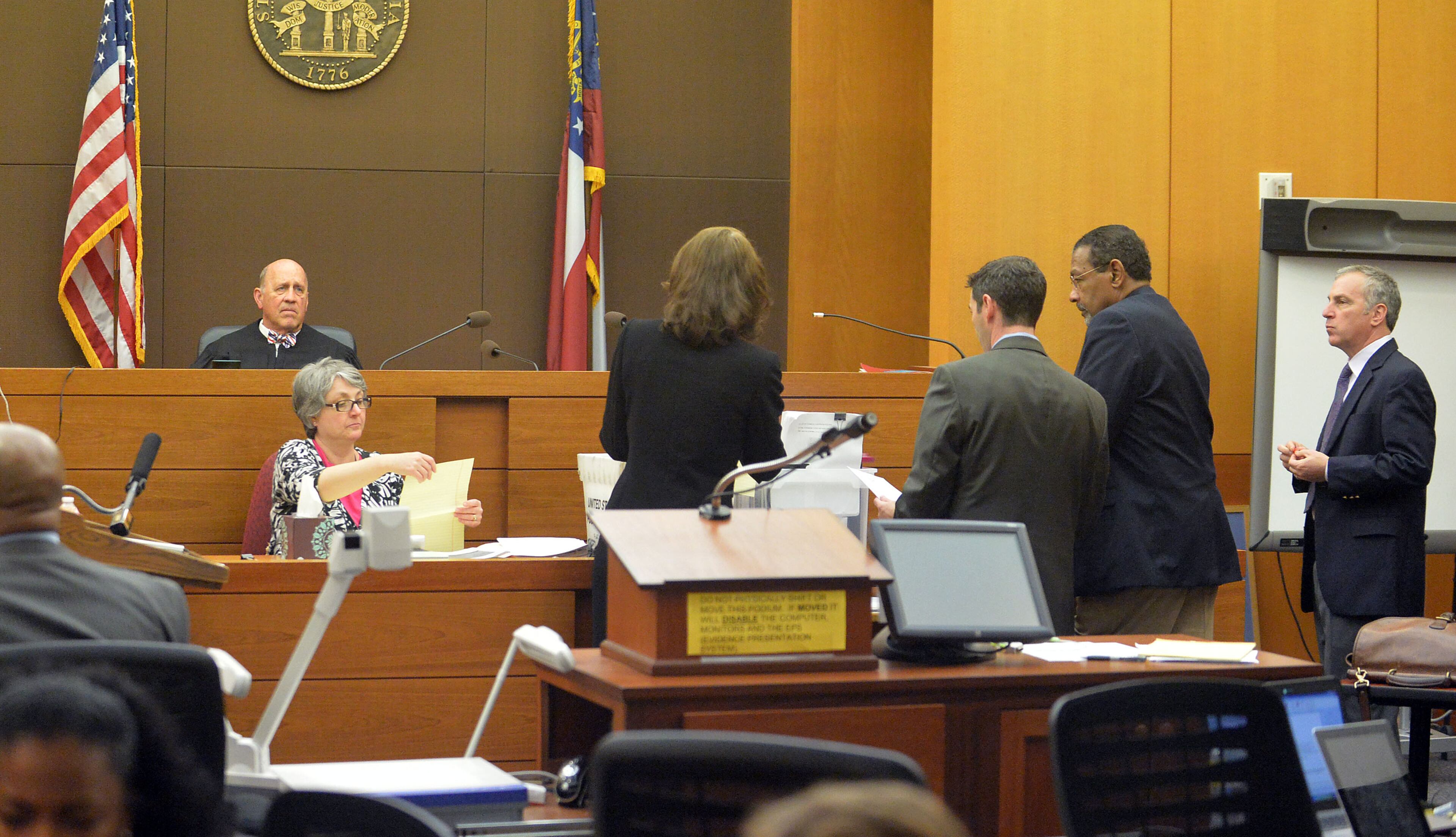 Defense attorneys and prosecutors craft a response to a jury question before Fulton County Superior Court Judge Jerry Baxter Thursday afternoon in the Atlanta Public Schools test-cheating trial. (Atlanta Journal-Constitution, Kent D. Johnson, Pool)