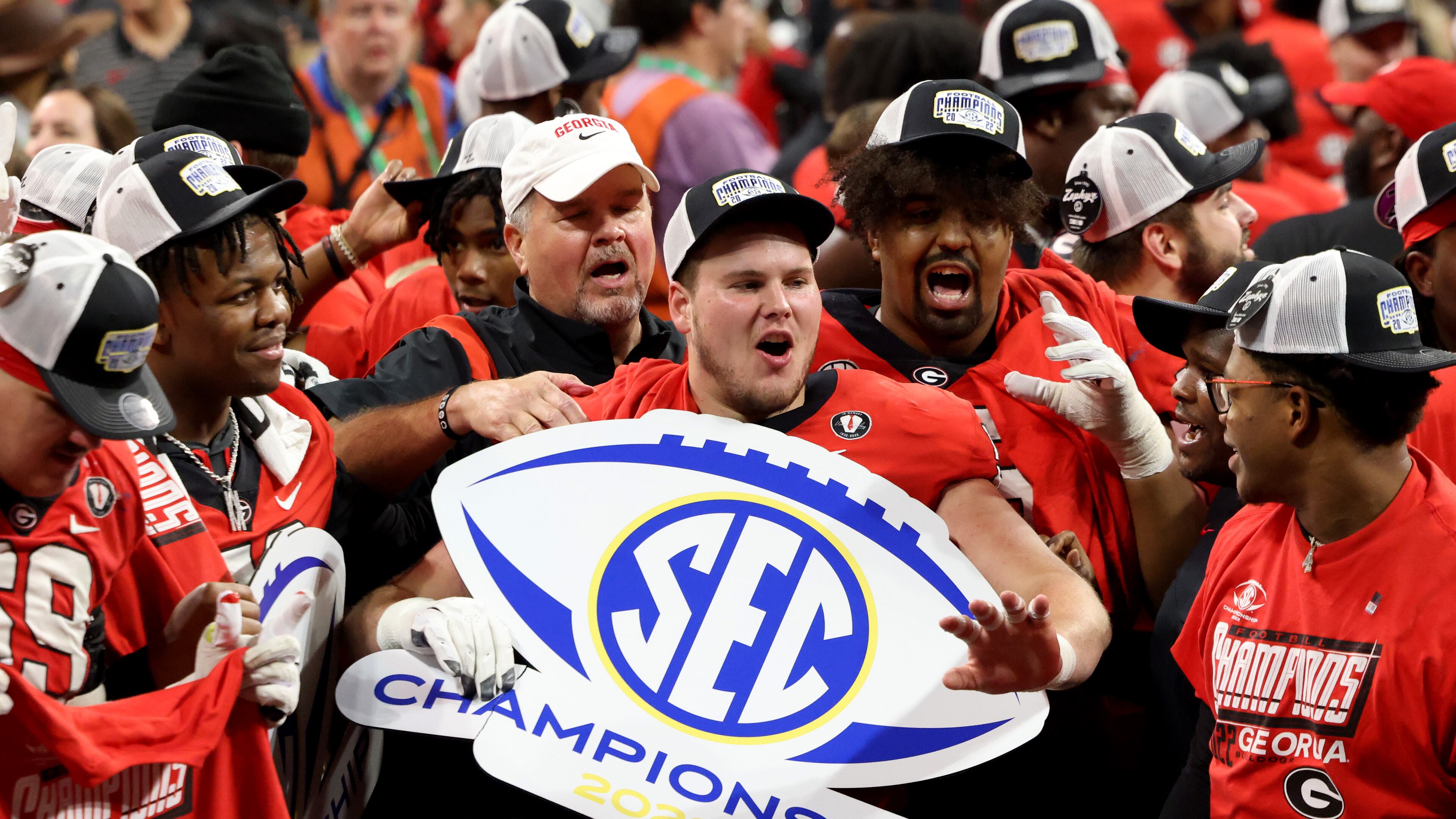 Bulldogs offensive lineman Warren Ericson holds an SEC Championship sign after their 50-30 win against LSU on Saturday at Mercedes-Benz Stadium. Georgia will play Ohio State in the Peach Bowl on Dec. 31 in a national semifinal in Atlanta. (Jason Getz / Jason.Getz@ajc.com)
