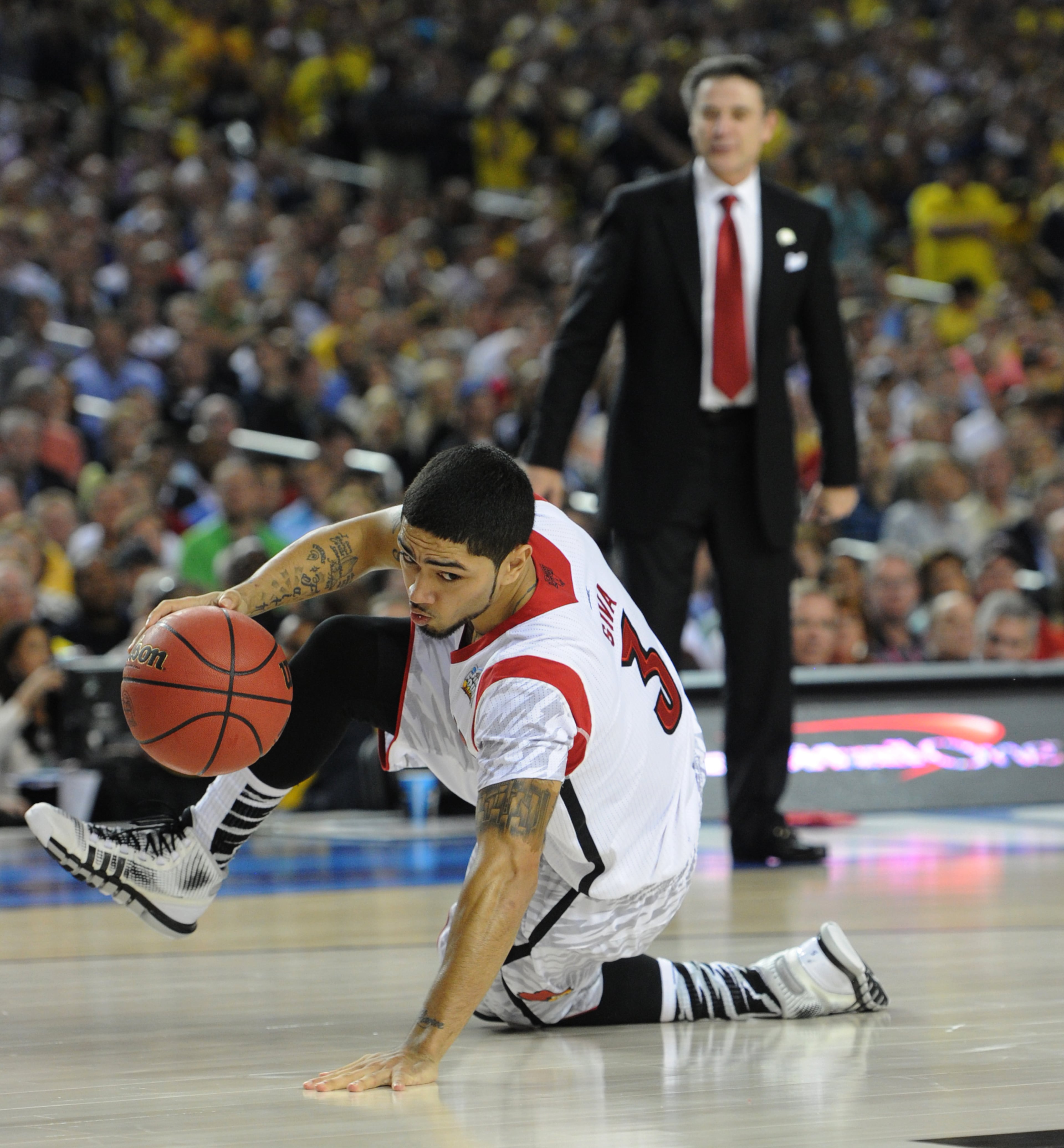 April 8, 2013 - Atlanta: Louisville's Peyton Siva keeps his dribble alive after falling to the floor during 2013 NCAA Division 1 Men's National Championship game inside the Georgia Dome in Atlanta on Monday, April 8, 2013. JOHNNY CRAWFORD / JCRAWFORD@AJC.COM