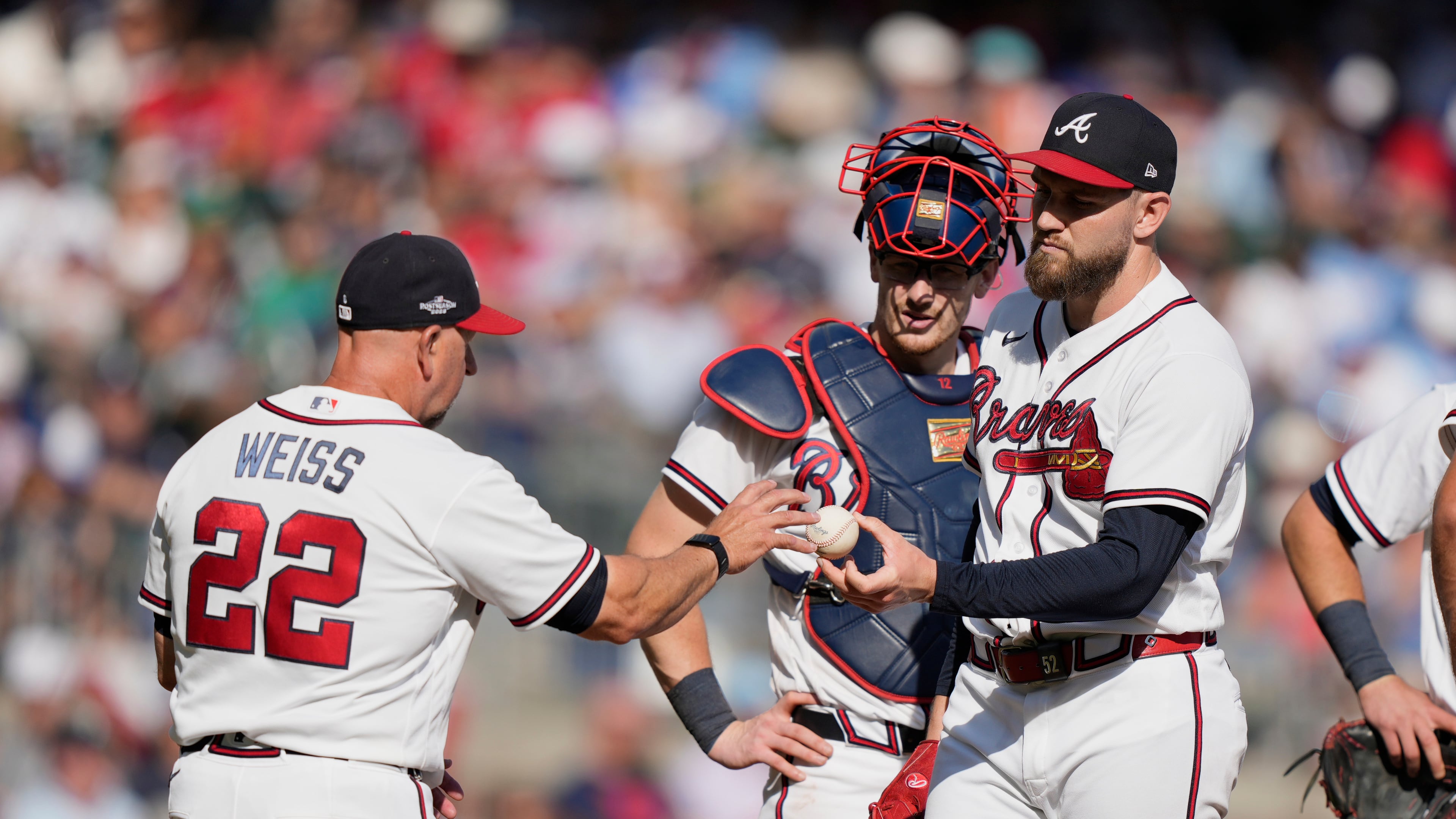 Atlanta Braves manager Walt Weiss (22) takes the ball from pitcher Dylan Lee in the eighth inning during Game 2 of baseball's National League Wild Card Series Wednesday, Sept. 30, 2026, in Atlanta. (AP Photo/Brynn Anderson)