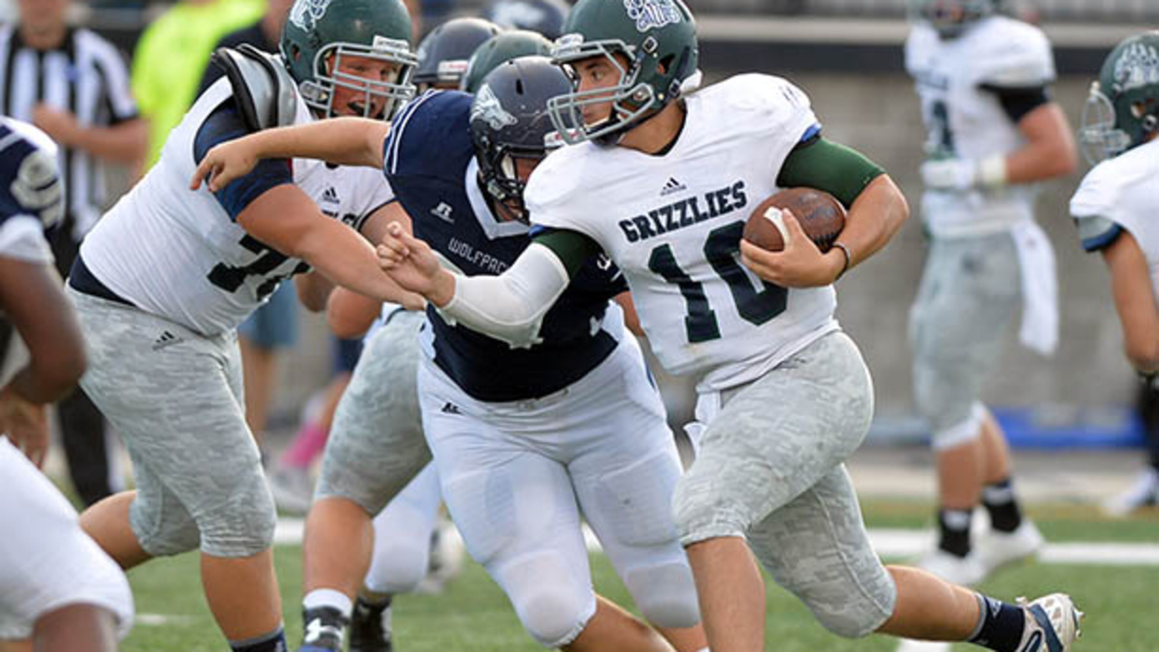 AUGUST 22, 2014 POWDER SPRINGS Walter H. Cantrell Stadium Friday, August 22, 2014. KENT D. JOHNSON / KDJOHNSON@AJC.COM Creekview quarterback Kyle Wilkie runs on the keeper during the first half in the initial game of the 2014 Corky Kell Classic between the Creekview Grizzlies and the North Paulding Wolfpack at McEachern High School. (Kent D. Johnson / AJC)